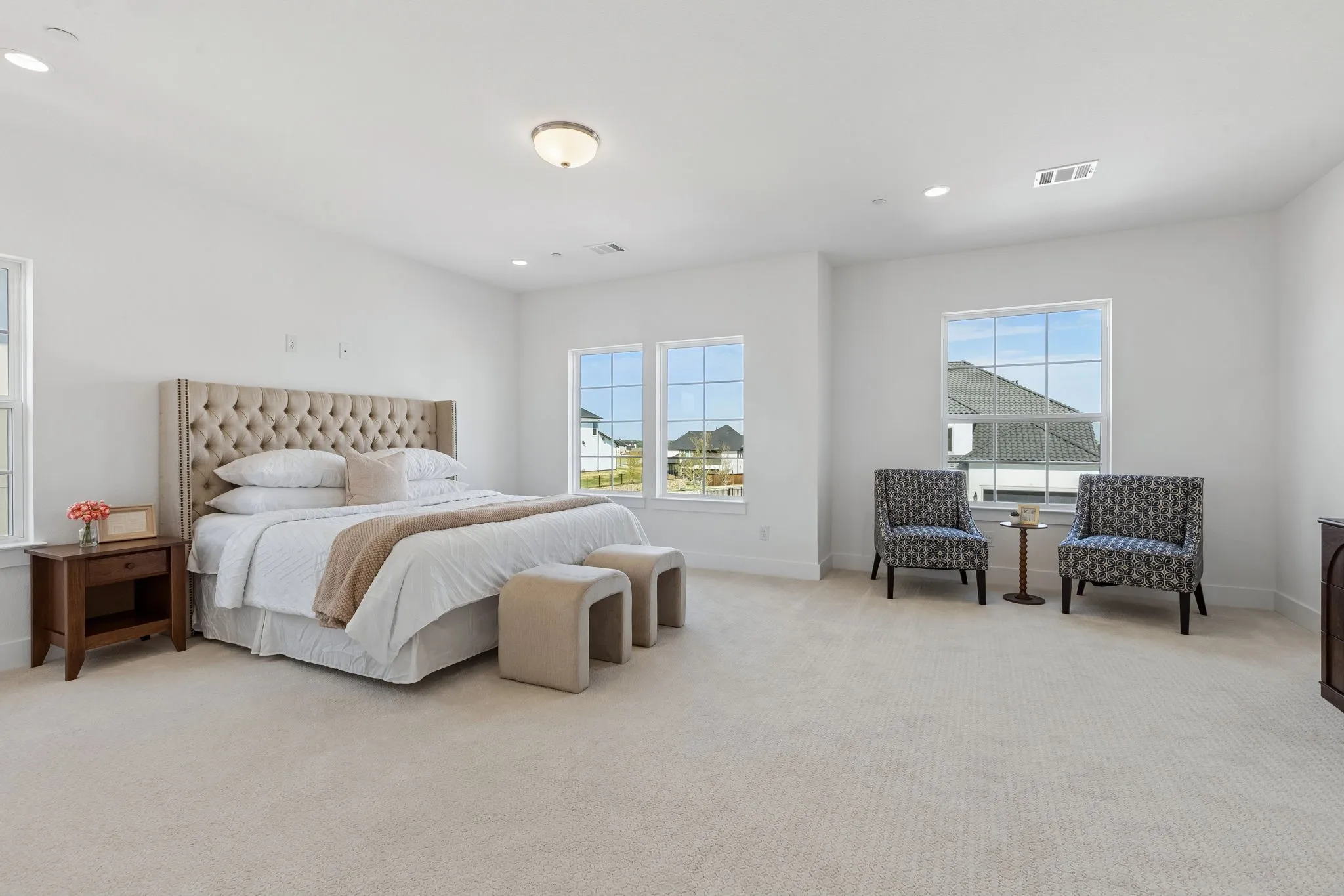 Expansive upstairs room with neutral carpeting, recessed lighting, and multiple windows