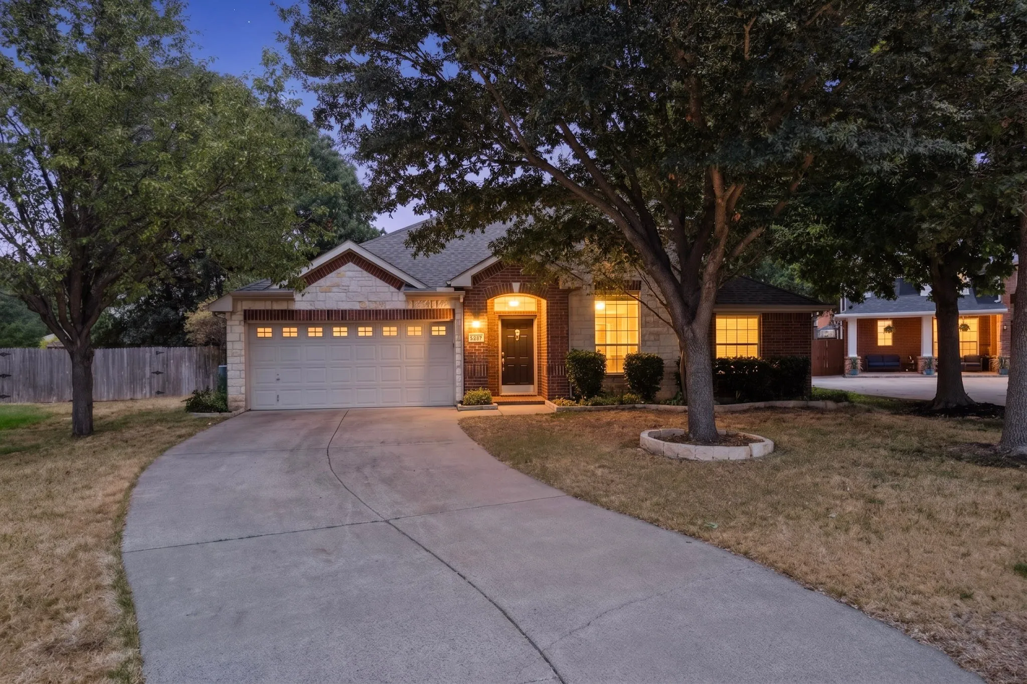 Brick and stone exterior with a two-car garage