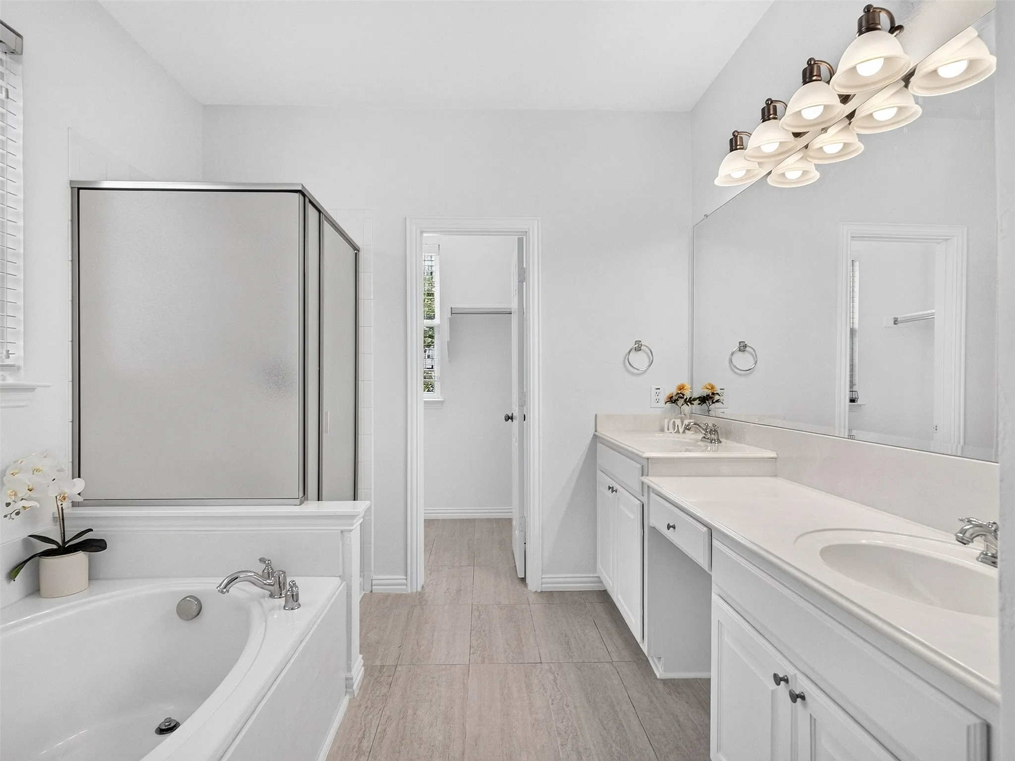 Dual vanity with white cabinetry and integrated sinks