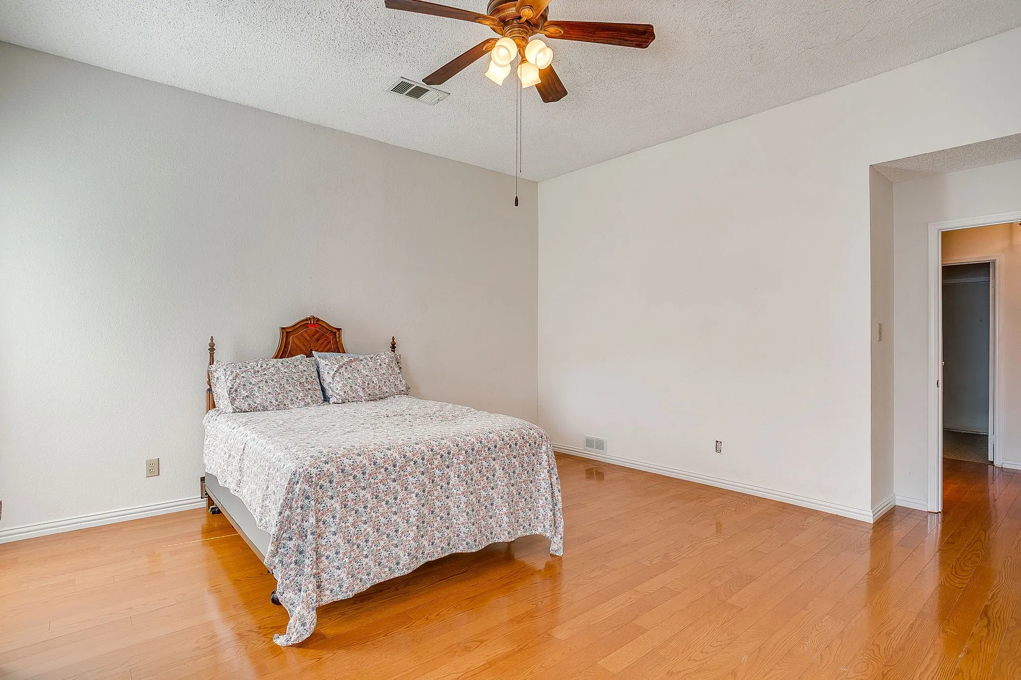 Wood flooring and ceiling fan.