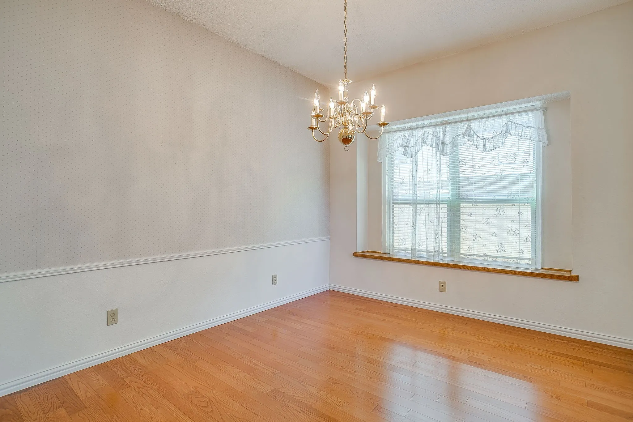 An elegant formal dining room accented with classic chair rail molding and abundant natural light, ideal for hosting holiday dinners or weekend game nights.