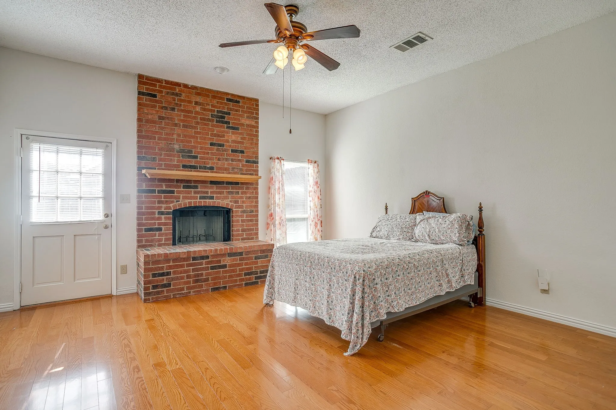 The primary suite features a direct exterior door to the backyard—perfect for letting the dog out or enjoying a quiet morning coffee.