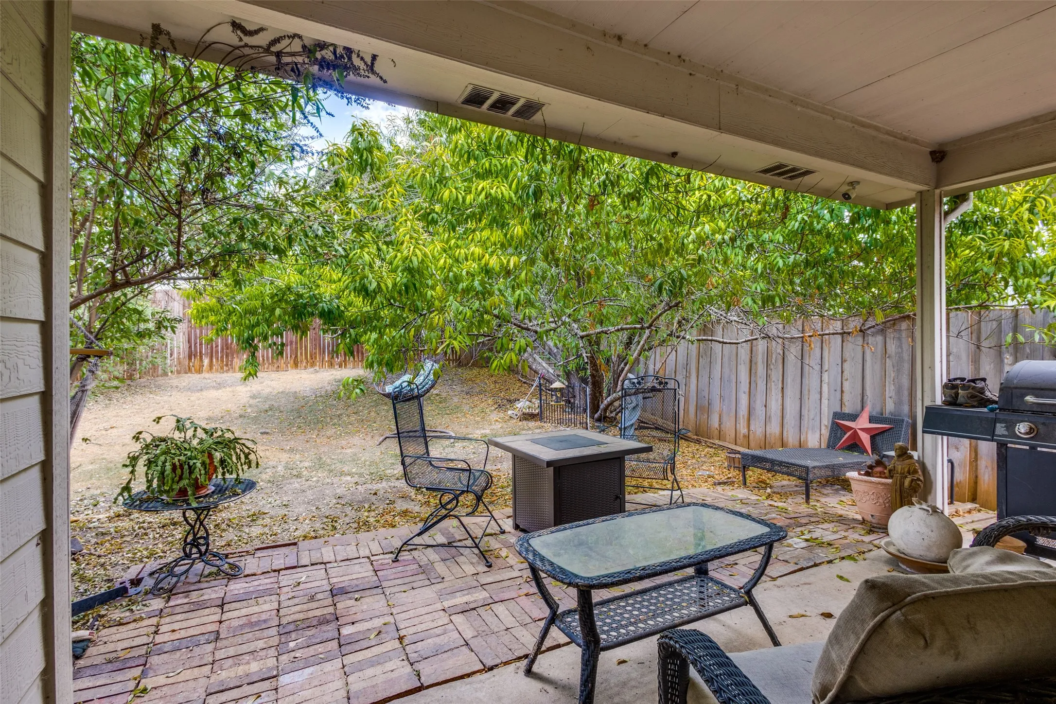 Covered patio featuring concrete and brick paving