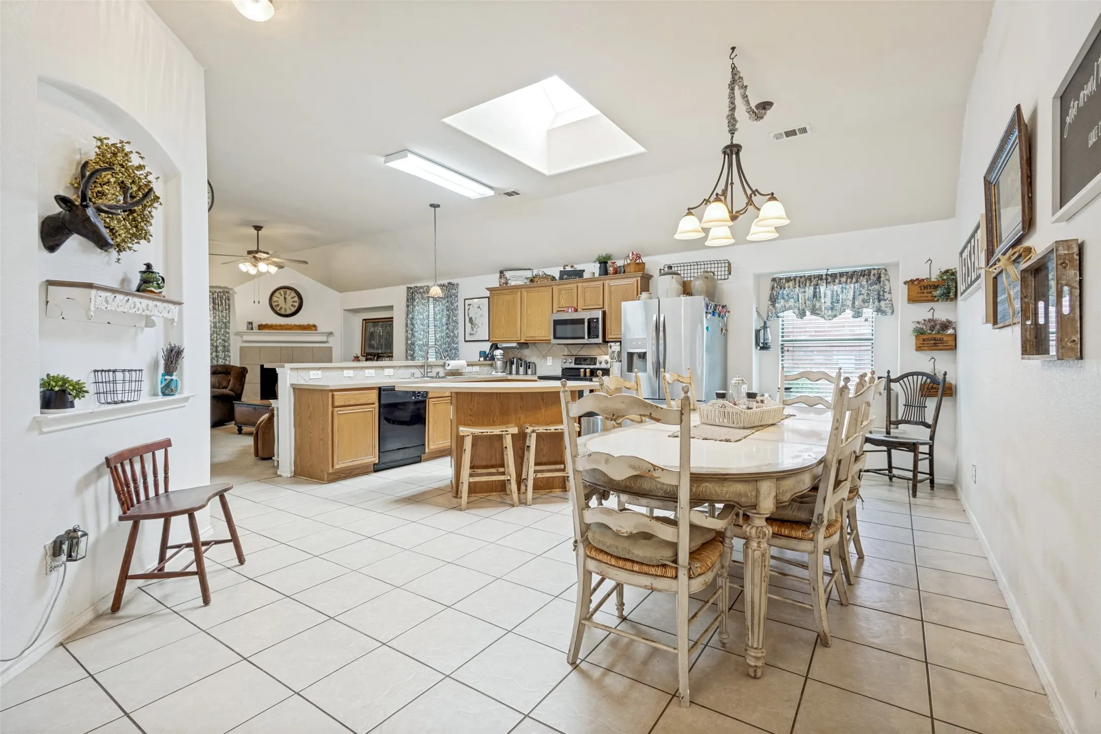Kitchen featuring light wood cabinetry,large dining area and a skylight for extra light.