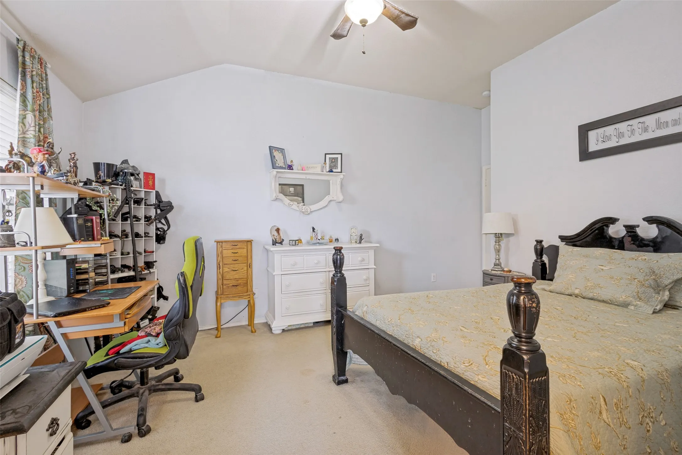 Vaulted ceiling and light paint welcome you into the primary bedroom.