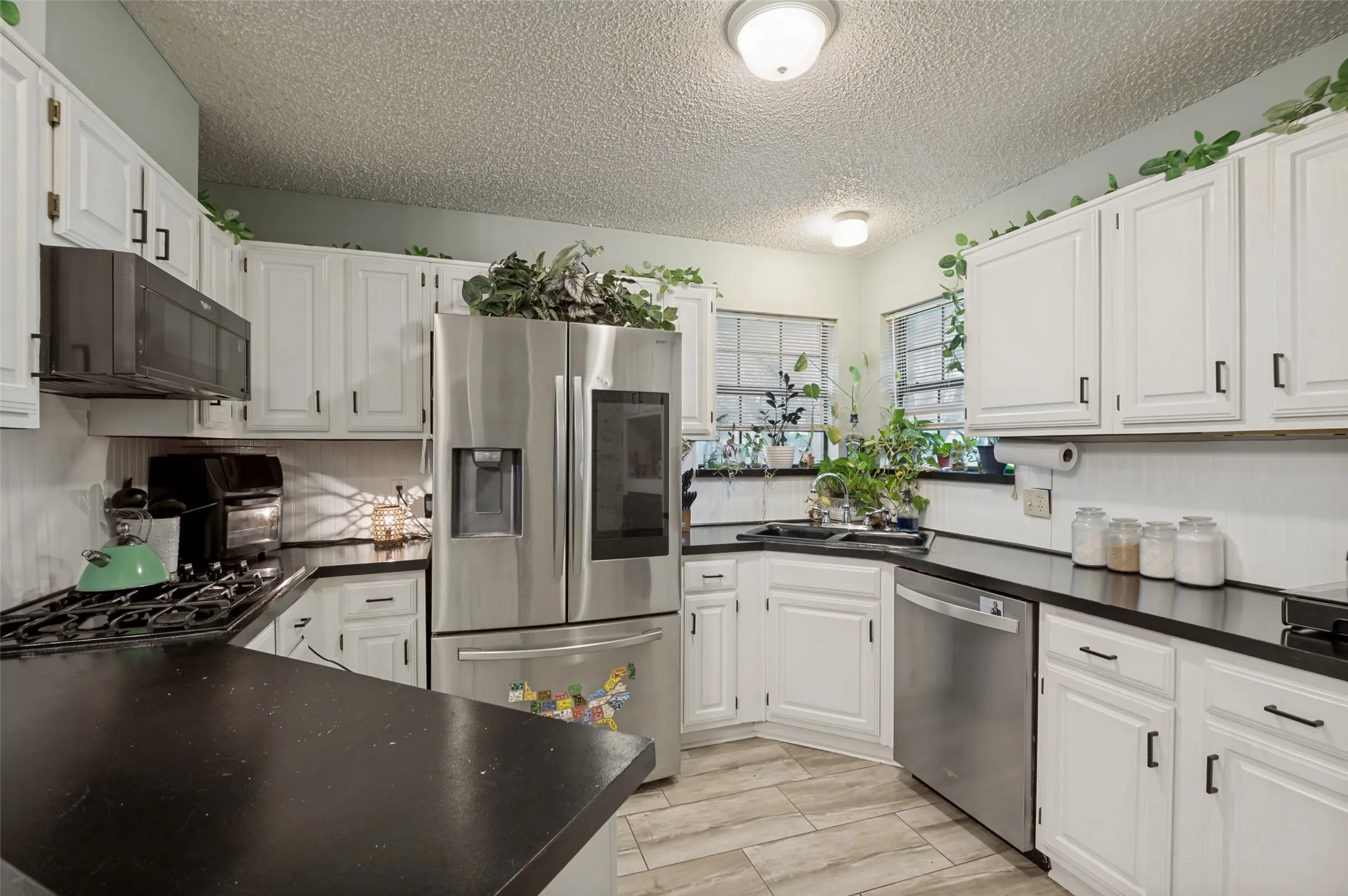 White cabinetry, black countertops
