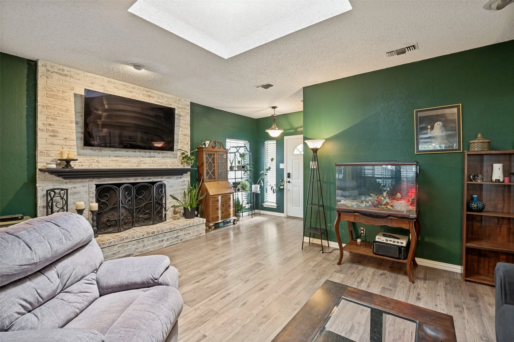 Fireplace featuring a light brick surround and dark mantel