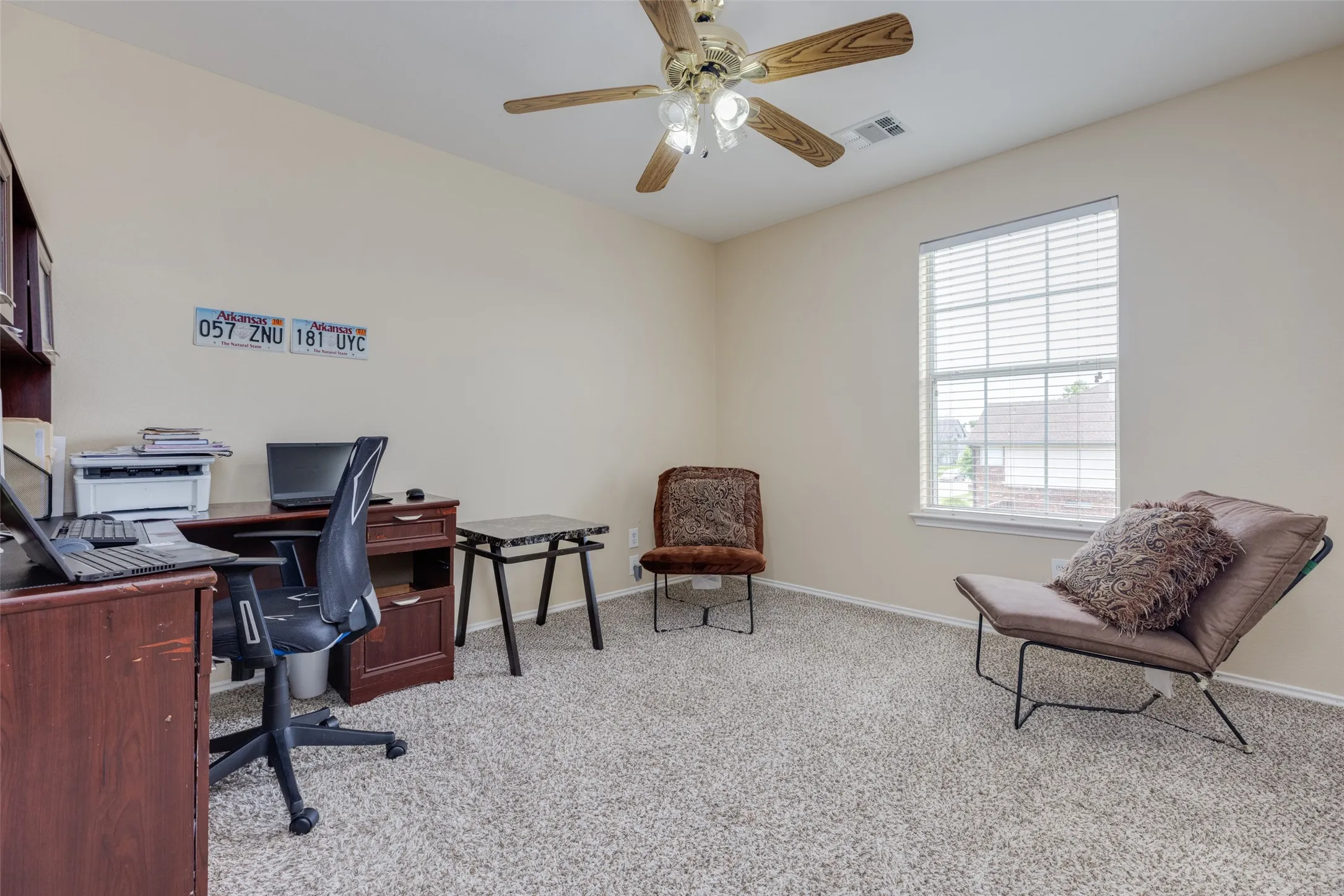 Wall-to-wall carpeting, window with blinds, and a ceiling fan with light fixture