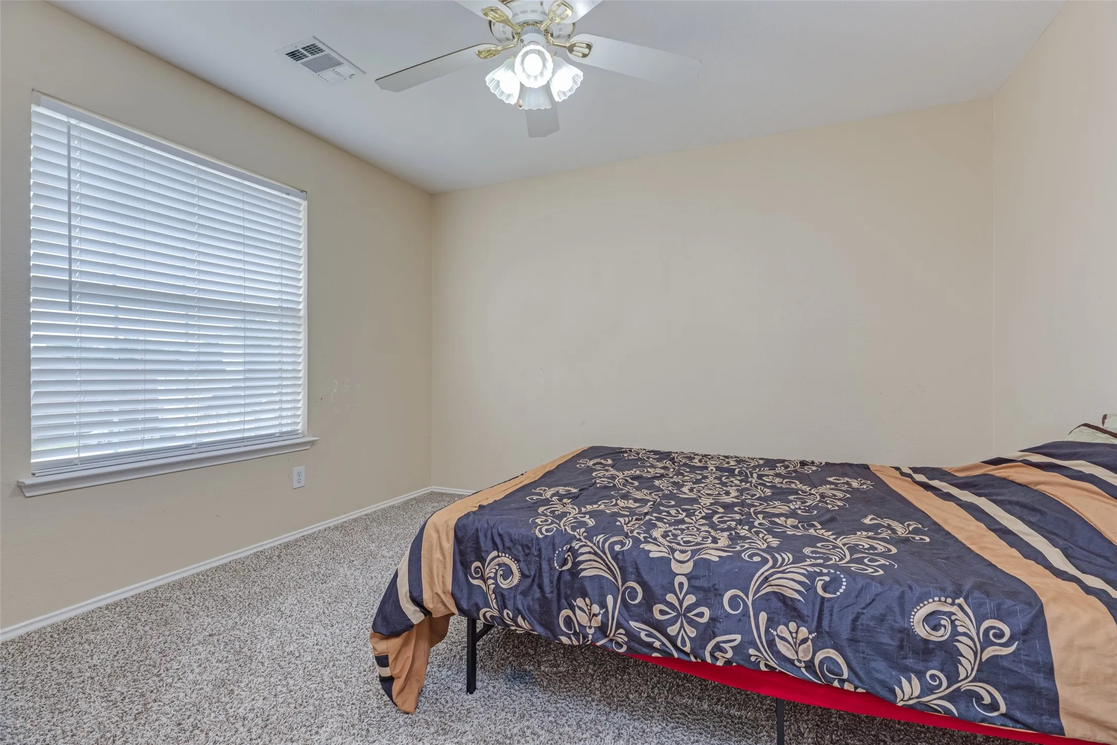 Neutral-toned walls complement plush carpeting