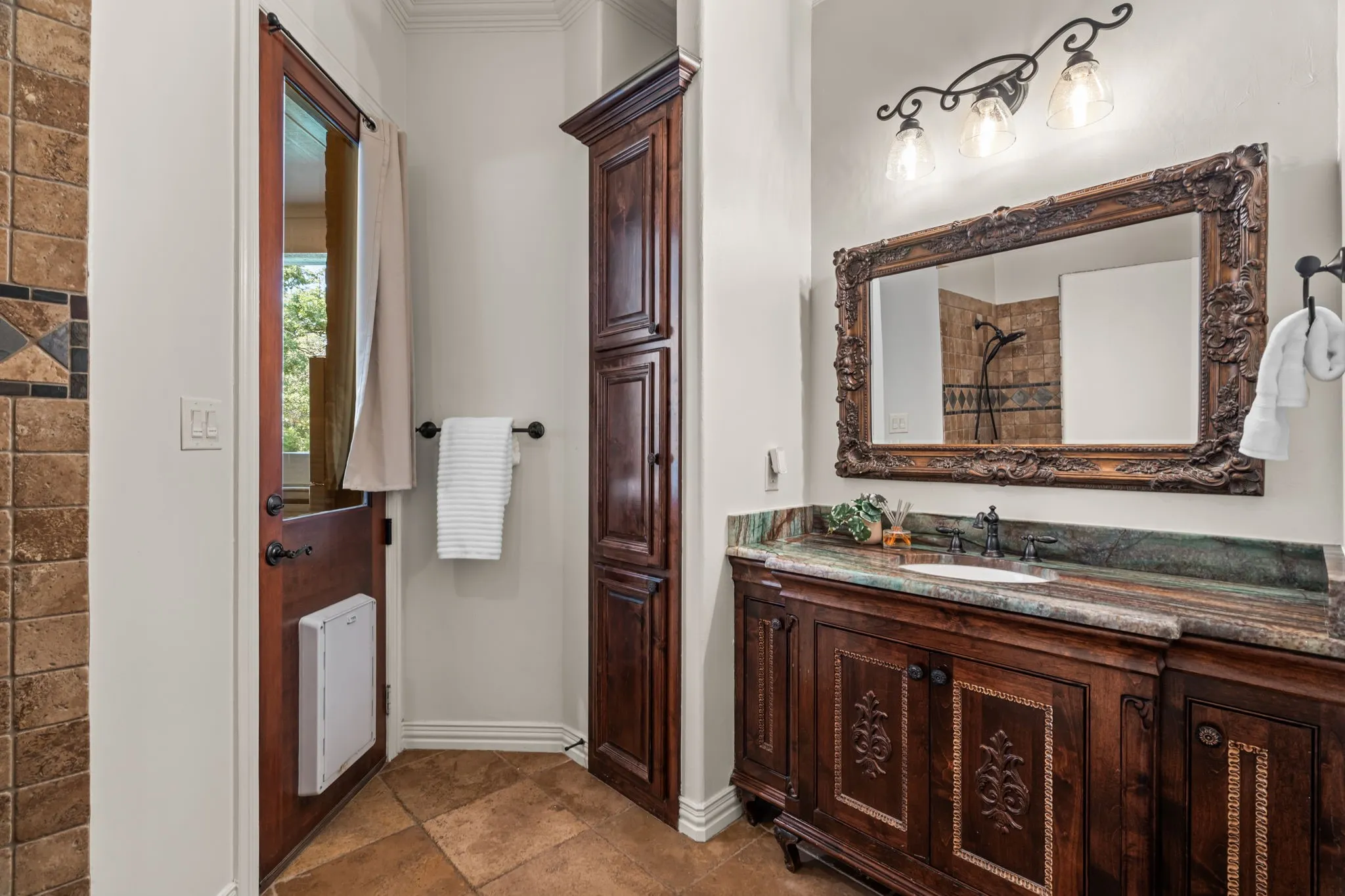 Vaulted ceiling with crown molding, recessed lighting, ceiling fan, and multiple windows including arched designs. Separate toilet area, walk in tile shower and exterior access to patio and pool