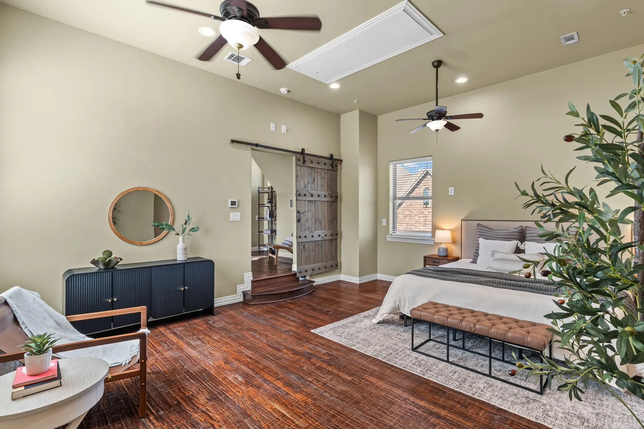 5th bedroom (no closet) is plumbed for a full en-suite bathroom and has wood-finish flooring, high ceilings with ceiling fans, recessed lighting, and a sliding barn door