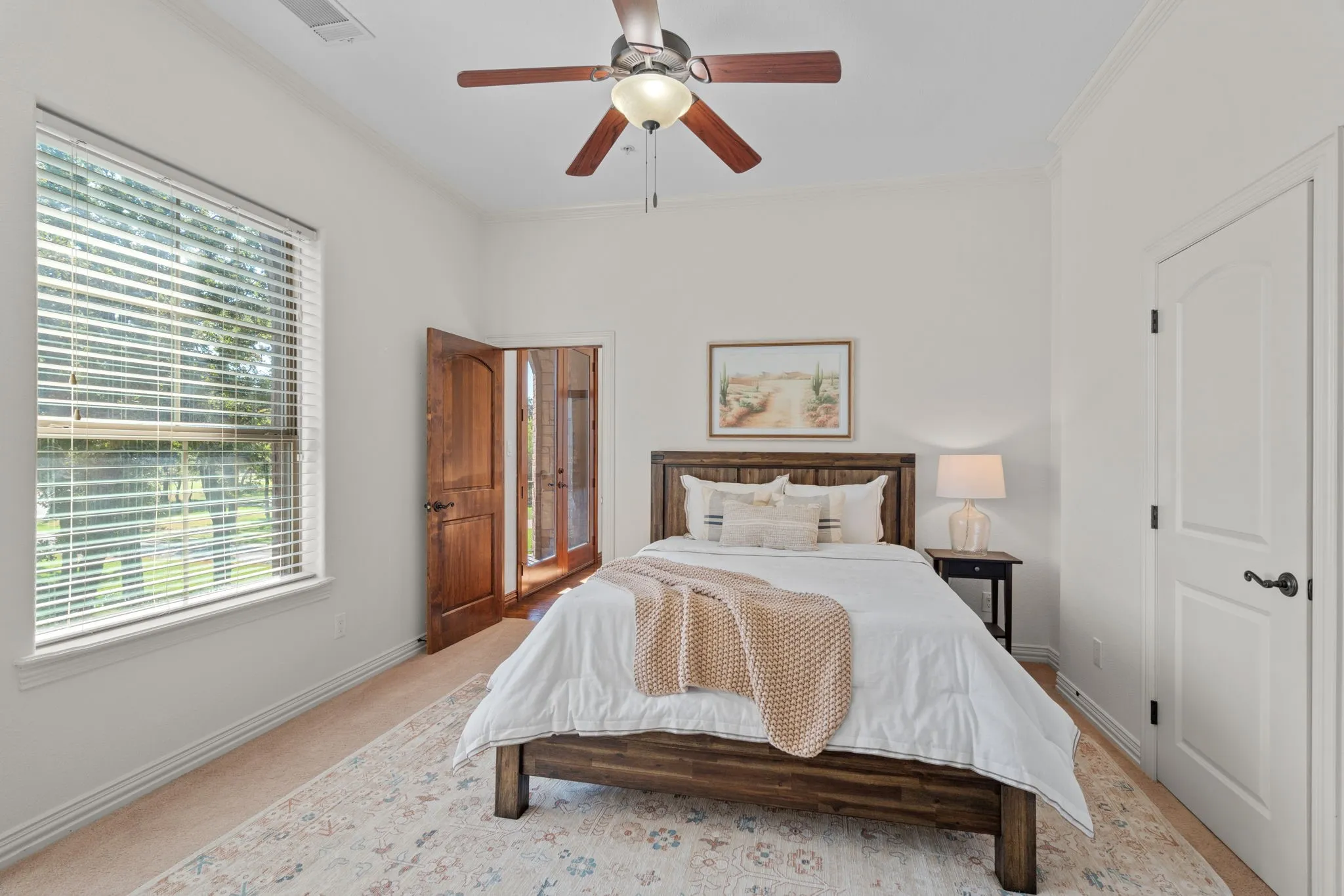 2nd floor bedroom with recessed windows, blinds, wood-finish ceiling fan, crown molding, and a solid white door with dark hardware and walk-in closet