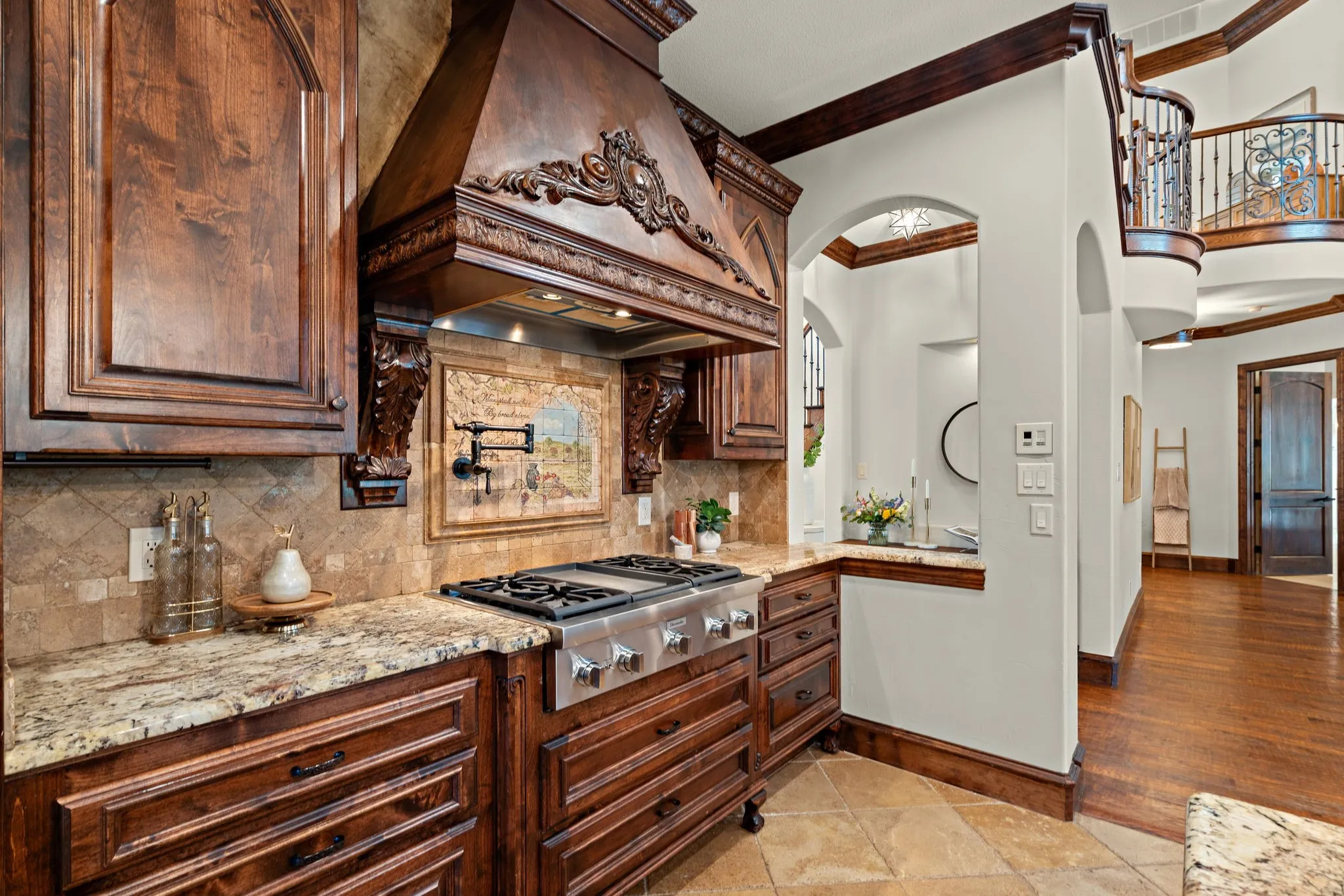 Gourmet kitchen with custom wood cabinetry, granite countertops, and a professional-grade gas range