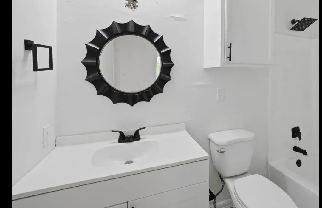 Vanity with integrated sink, matte black faucet, and white countertop