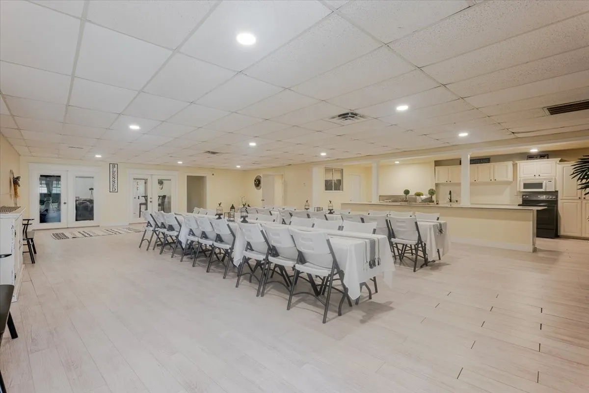 Additional view of dining/reception area with adjacent kitchen and laundry room.