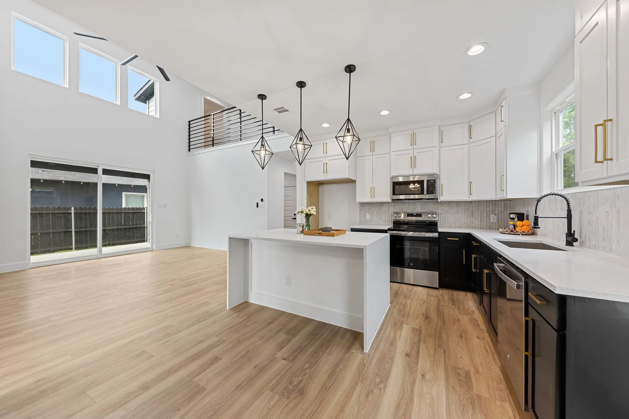 Open-concept living area with vaulted ceilings and abundant natural light