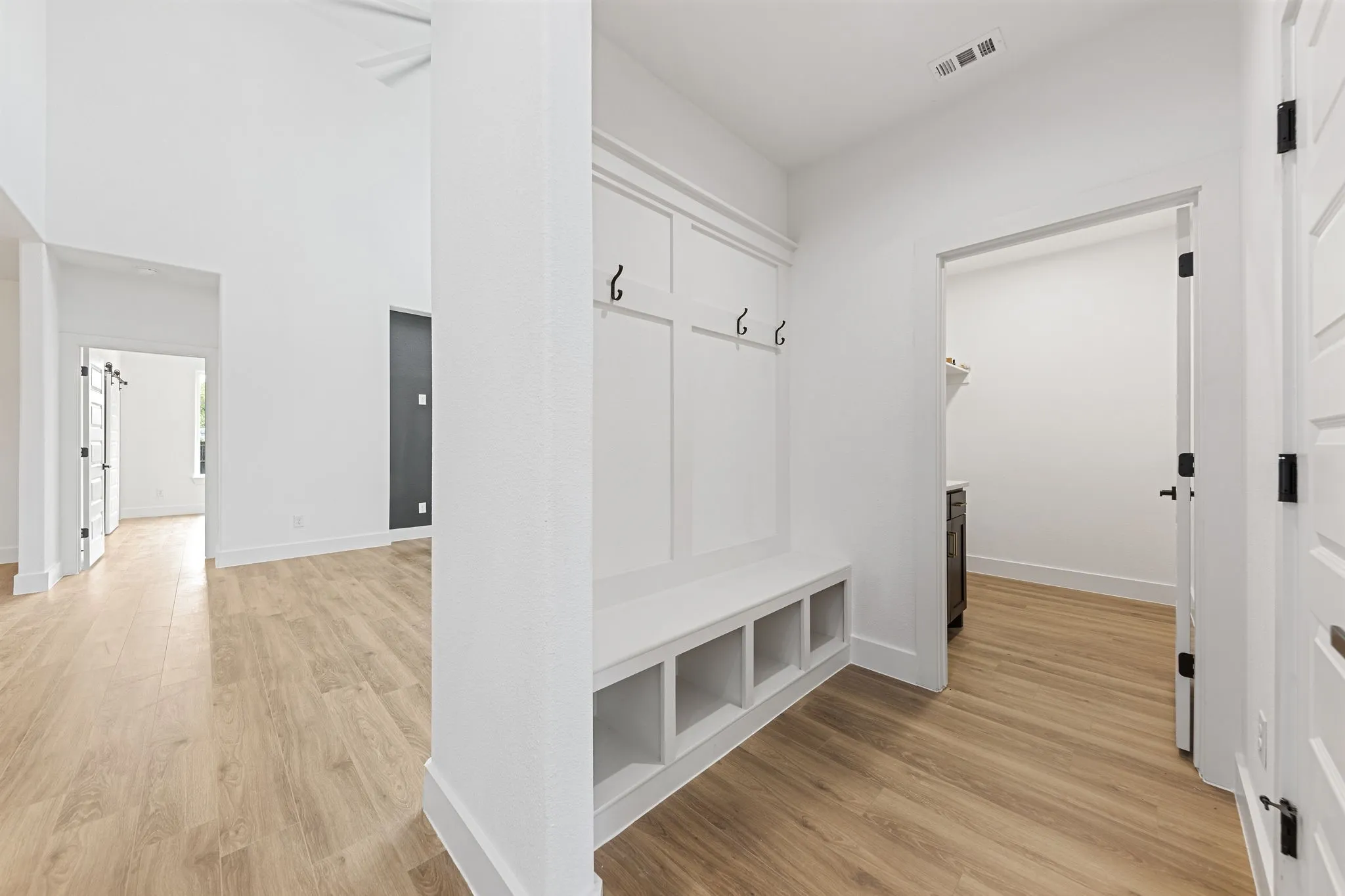 Built-in mudroom bench with cubby storage and coat hooks