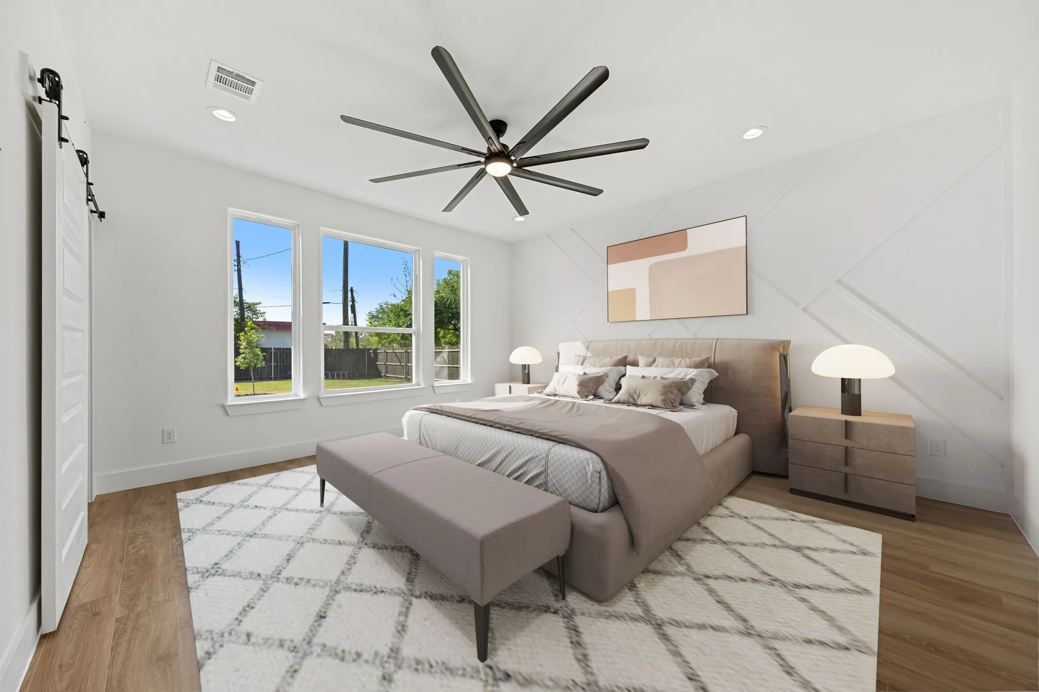 Wood-finish flooring, recessed lighting, ceiling fan with multiple blades, shiplap accent wall, and multiple windows