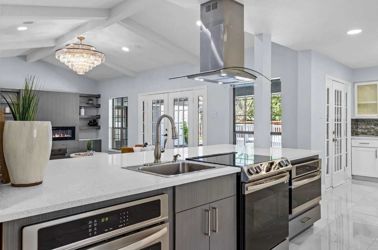 Kitchen island with integrated sink and stainless steel appliances