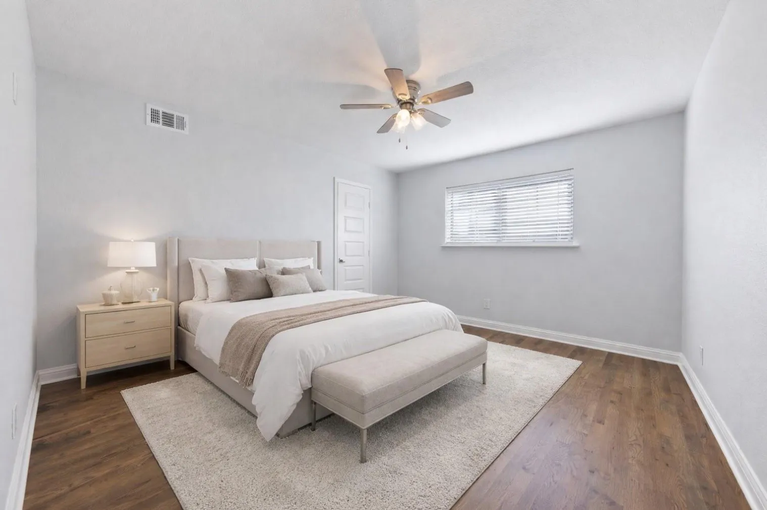 Wood-finish flooring with white baseboards