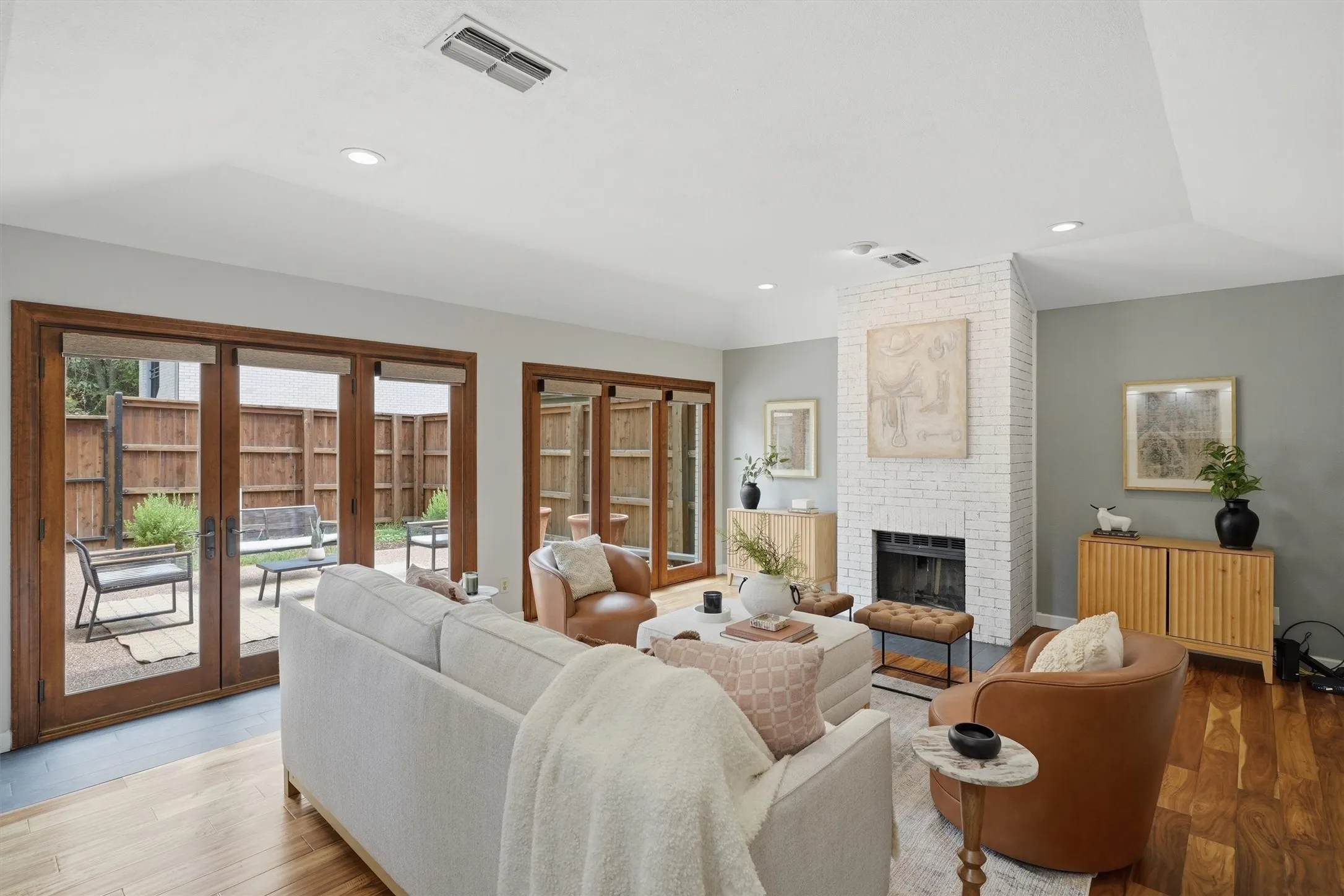 Direct access to outdoor living with charming wood trimmed glass doors expanding living space.