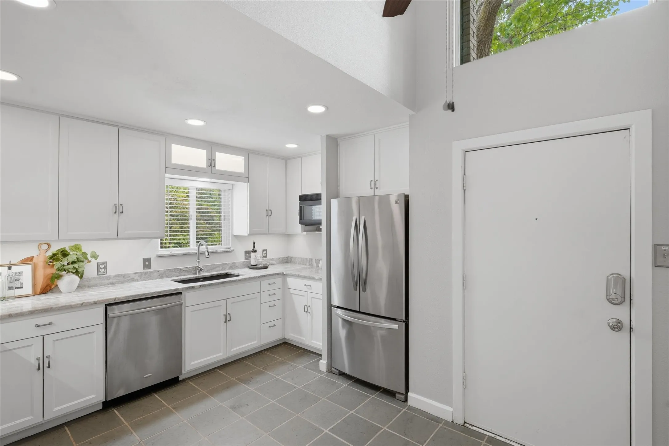 Soaring vaulted ceilings and high transom windows bring abundant natural light into this move-in-ready kitchen.