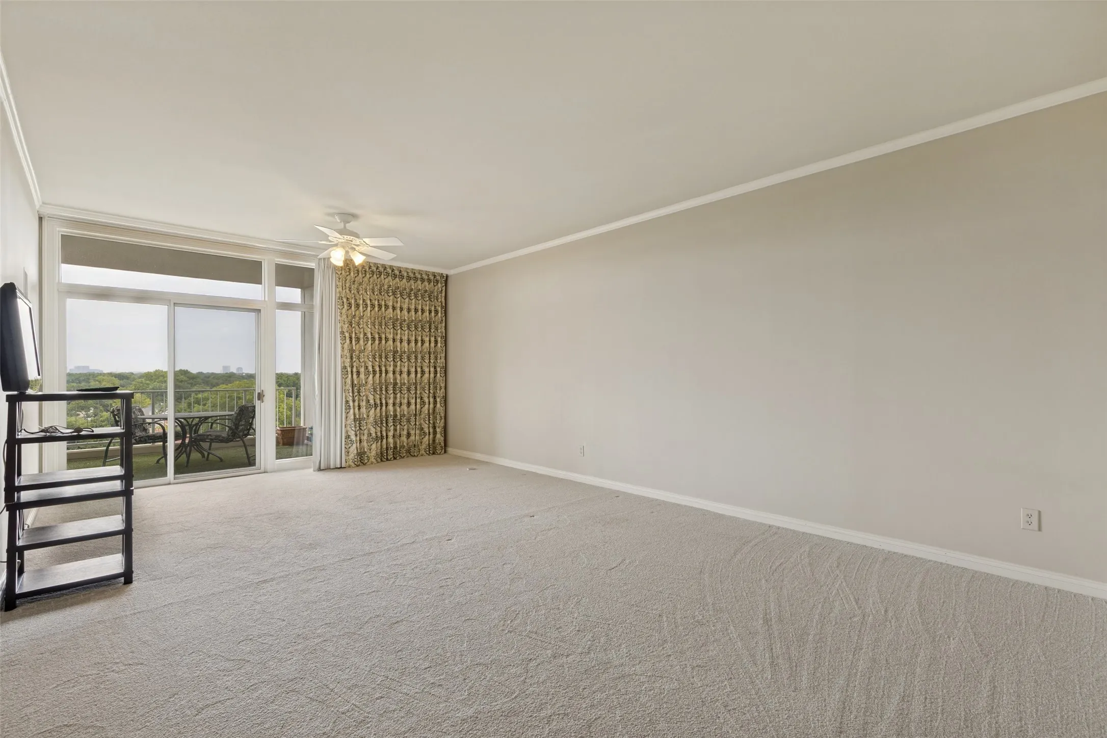 Large Primary bedroom has separate balcony entrance with view of Highland Park