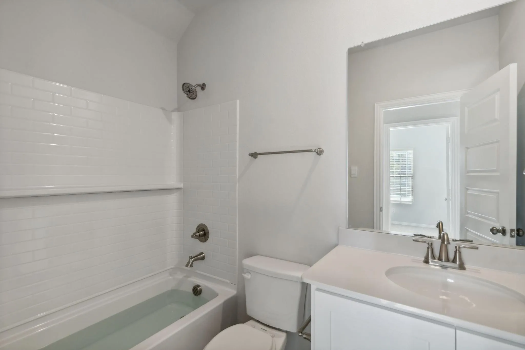 Bathroom with shower / washtub combination, vanity, and toilet
