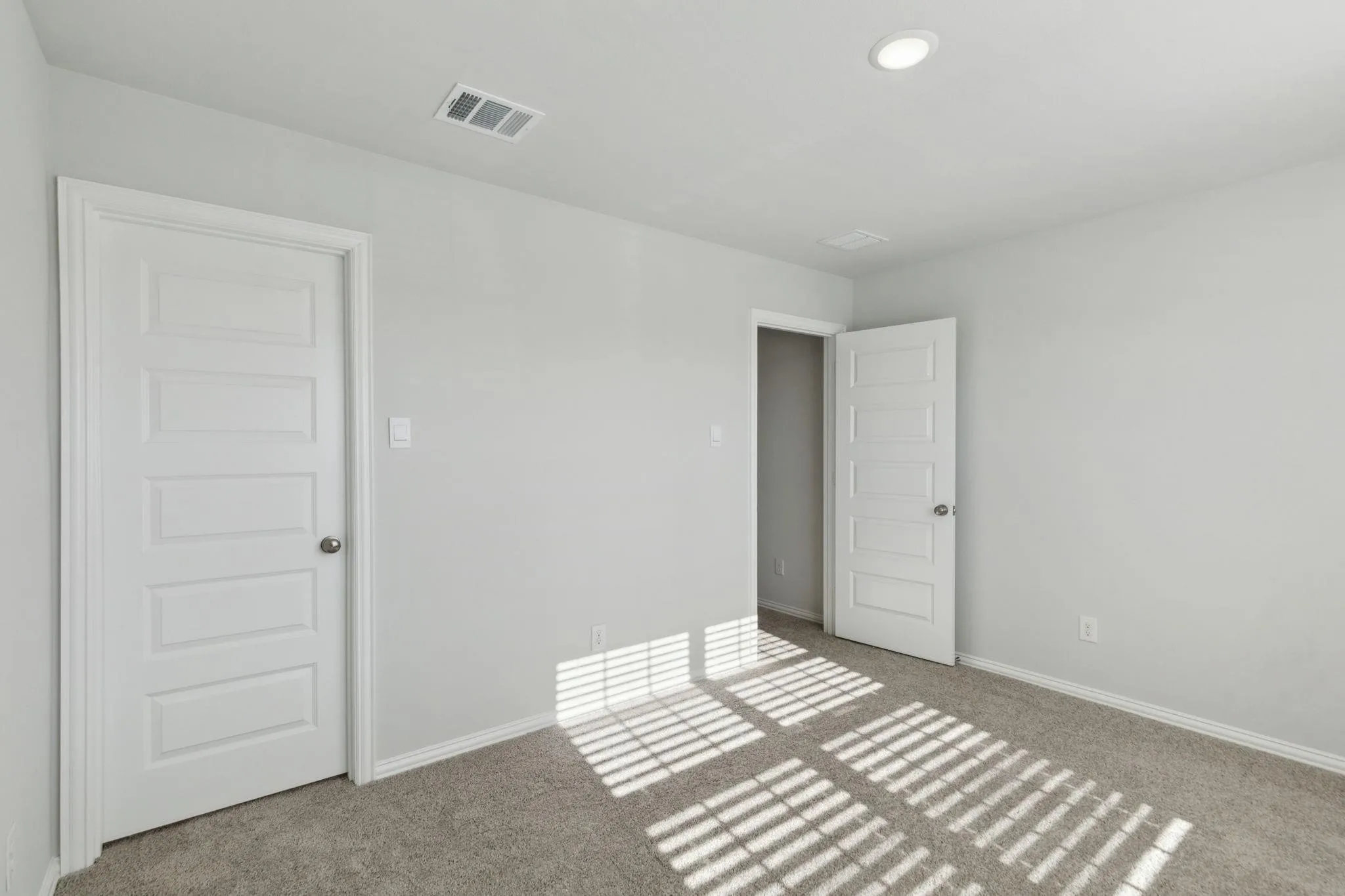 Empty room featuring carpet flooring and baseboards