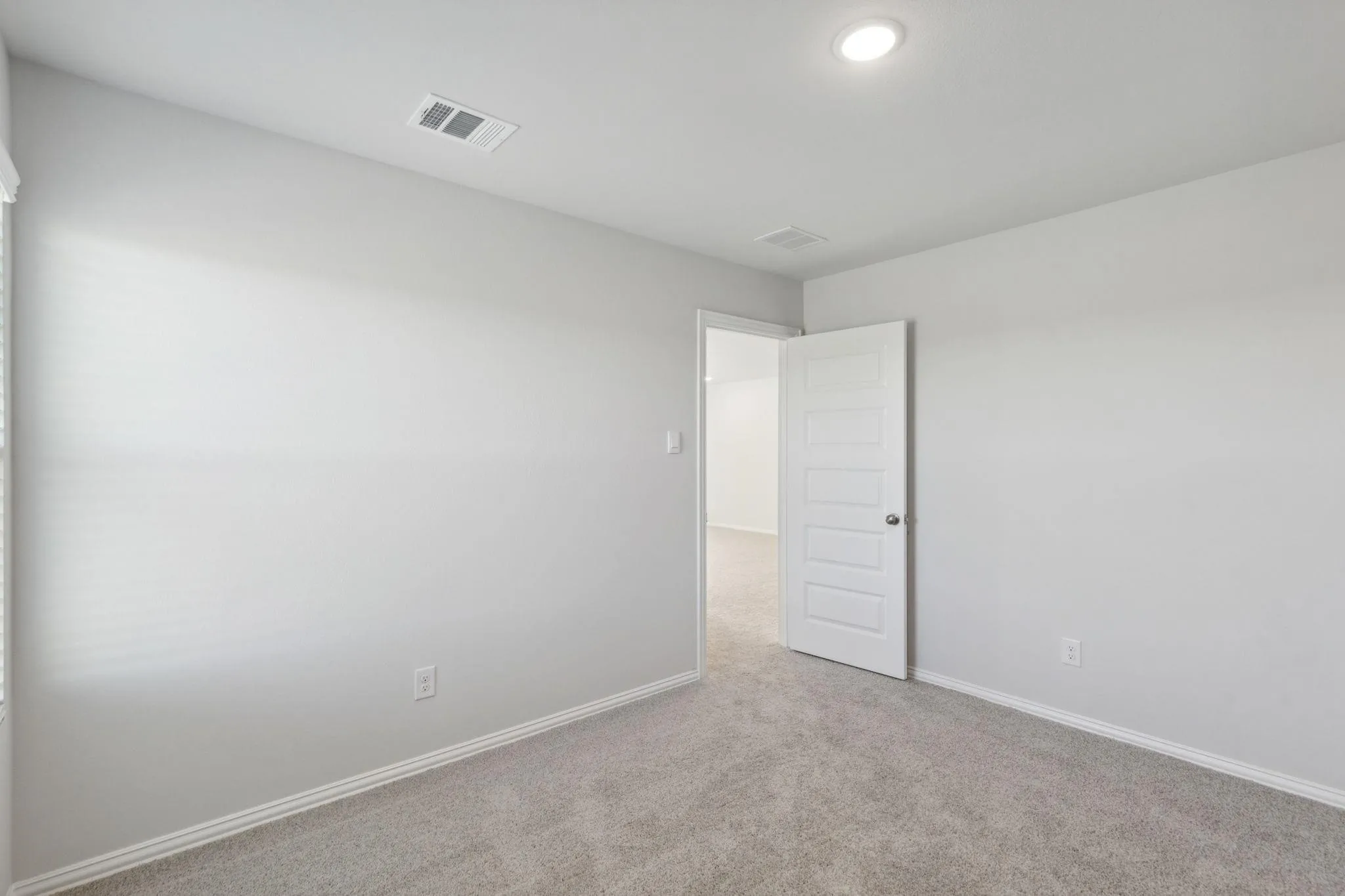 Unfurnished room featuring carpet and baseboards