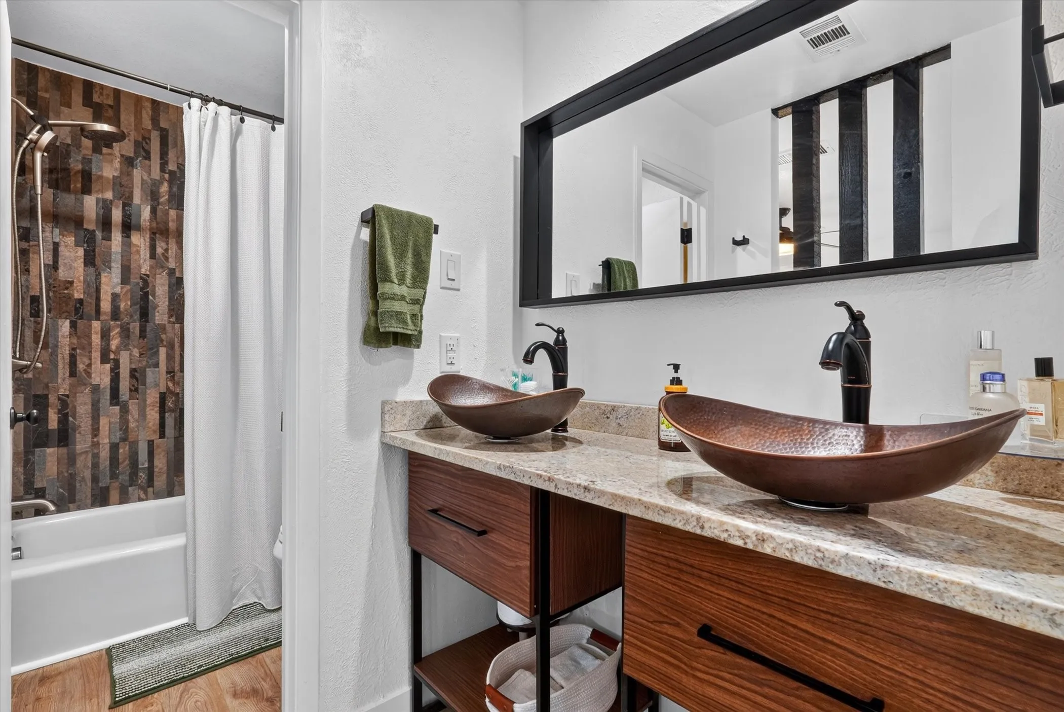 Double vanity with vessel sinks and bronze-finish faucets