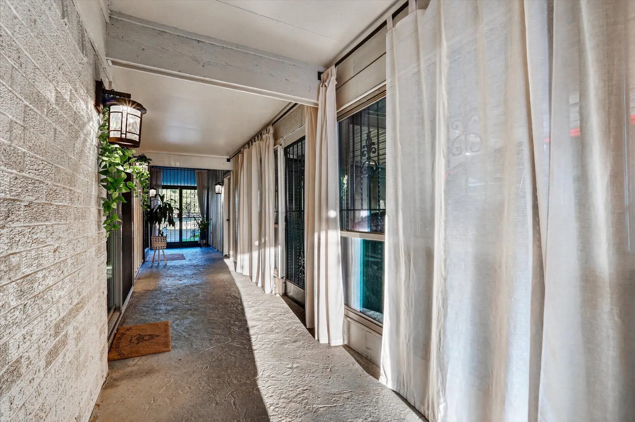 Covered entry with textured brick wall and overhead lighting