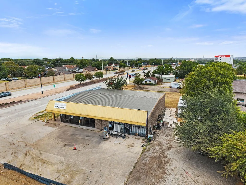 Commercial building with a metal roof and an expansive paved lot
