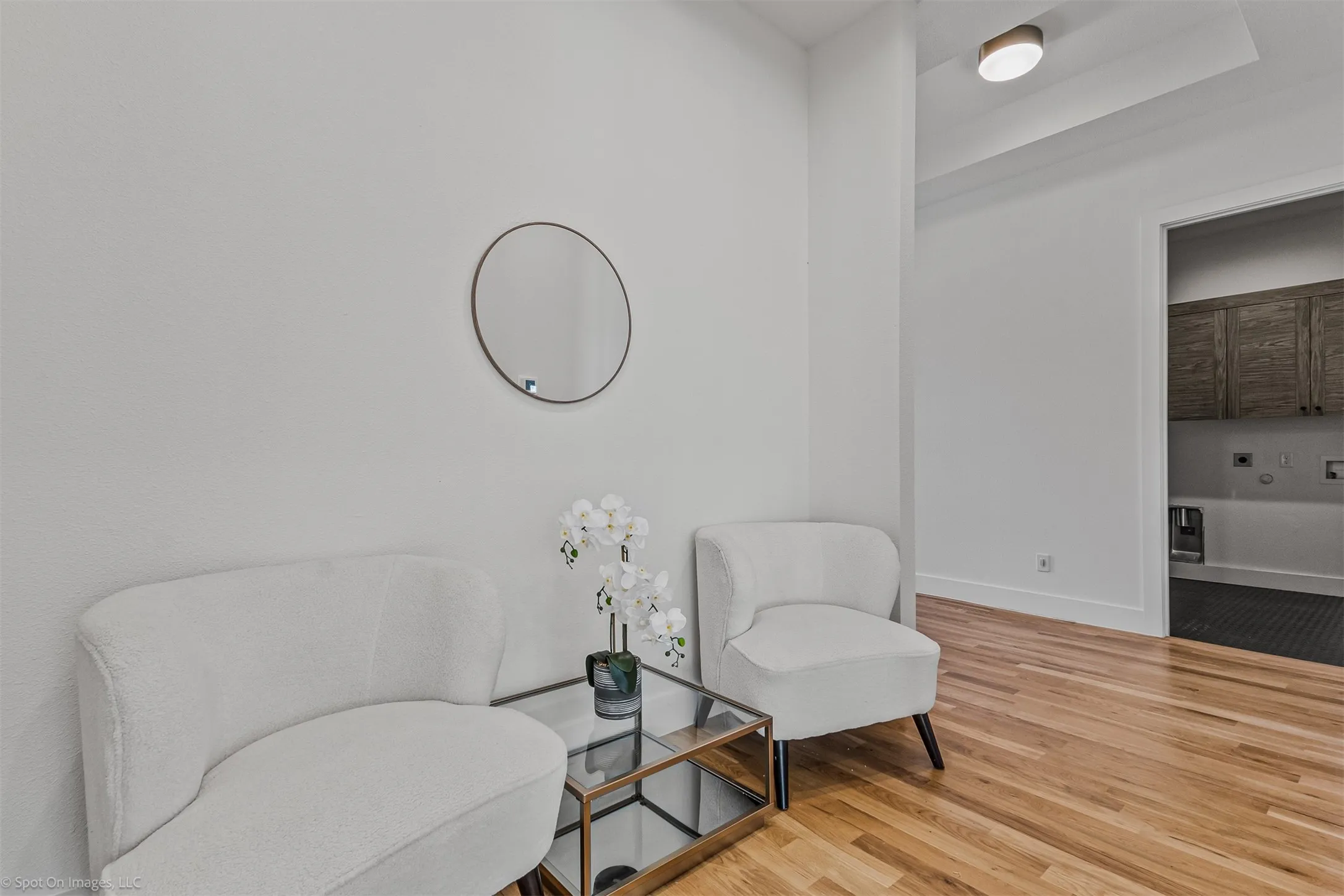 Hardwood flooring, recessed ceiling lighting, and a modern ceiling-mounted light fixture