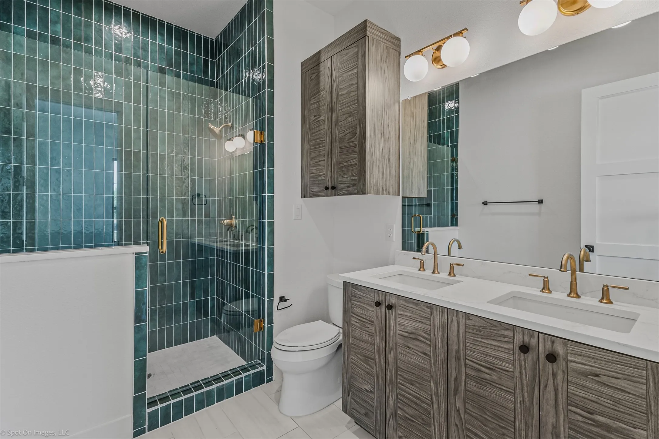 Dual vanity with undermount sinks and brass-finish fixtures