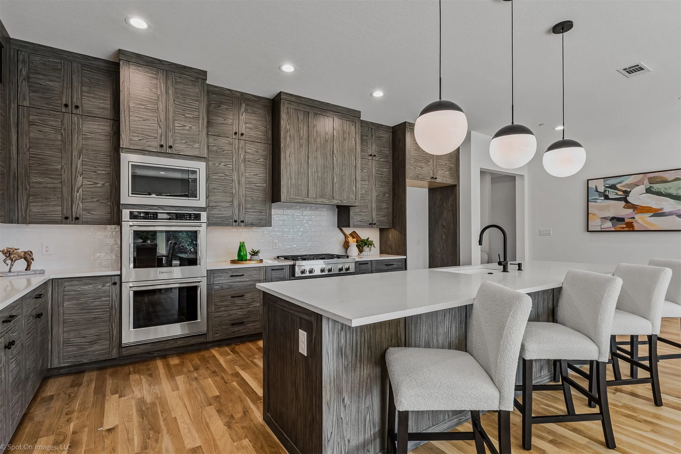 Wood-finish cabinetry paired with white countertops, stainless steel appliances, and a tile backsplash
