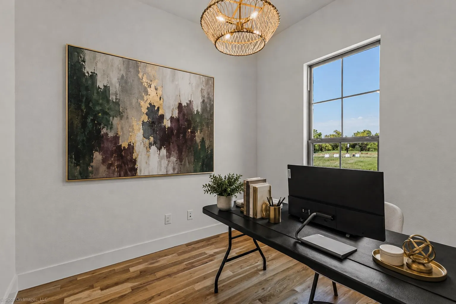 Recessed window with grid pattern, wood-finish flooring, white walls, and a woven pendant light fixture