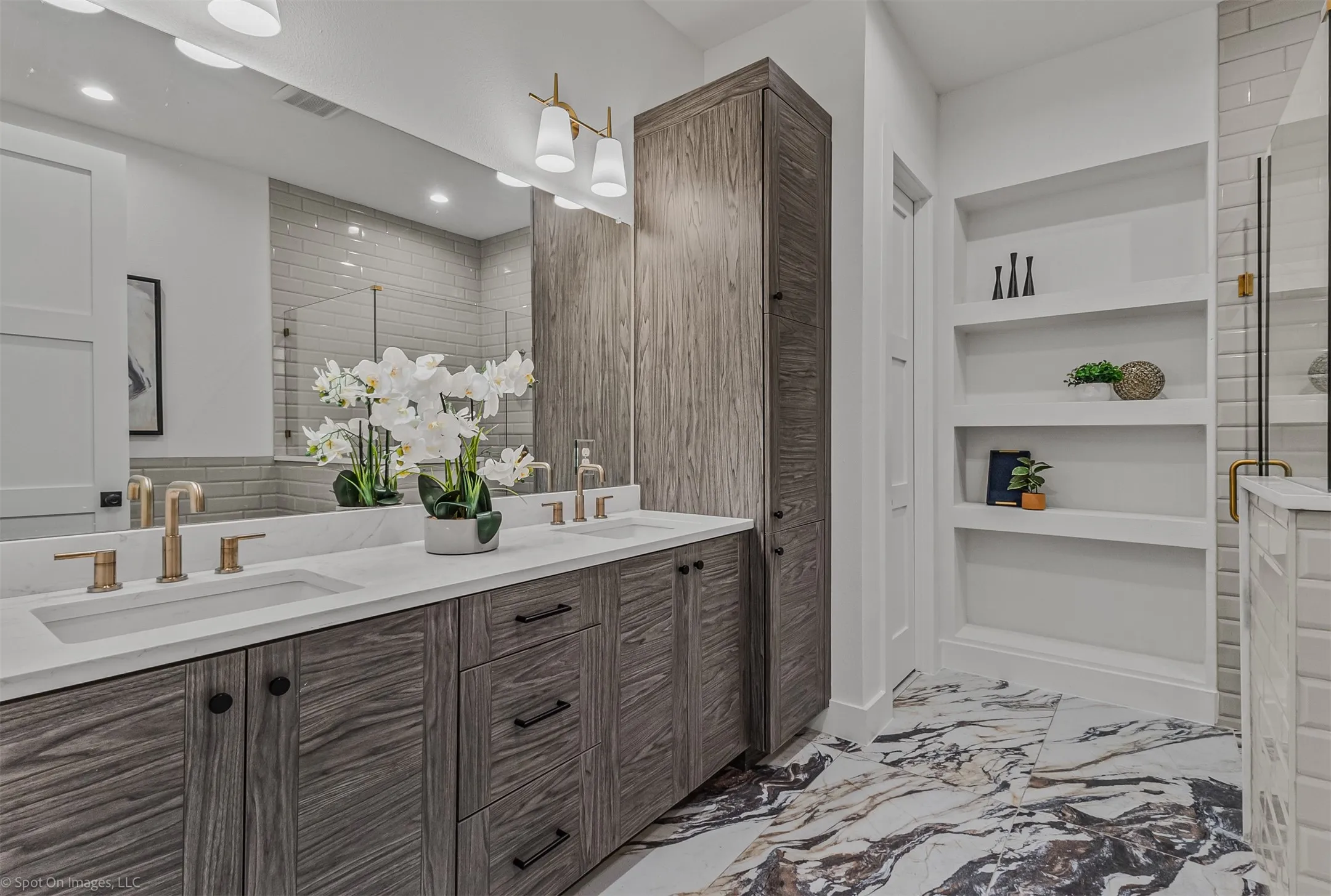Dual vanity featuring integrated sinks, bronze-finish fixtures, and quartz countertops