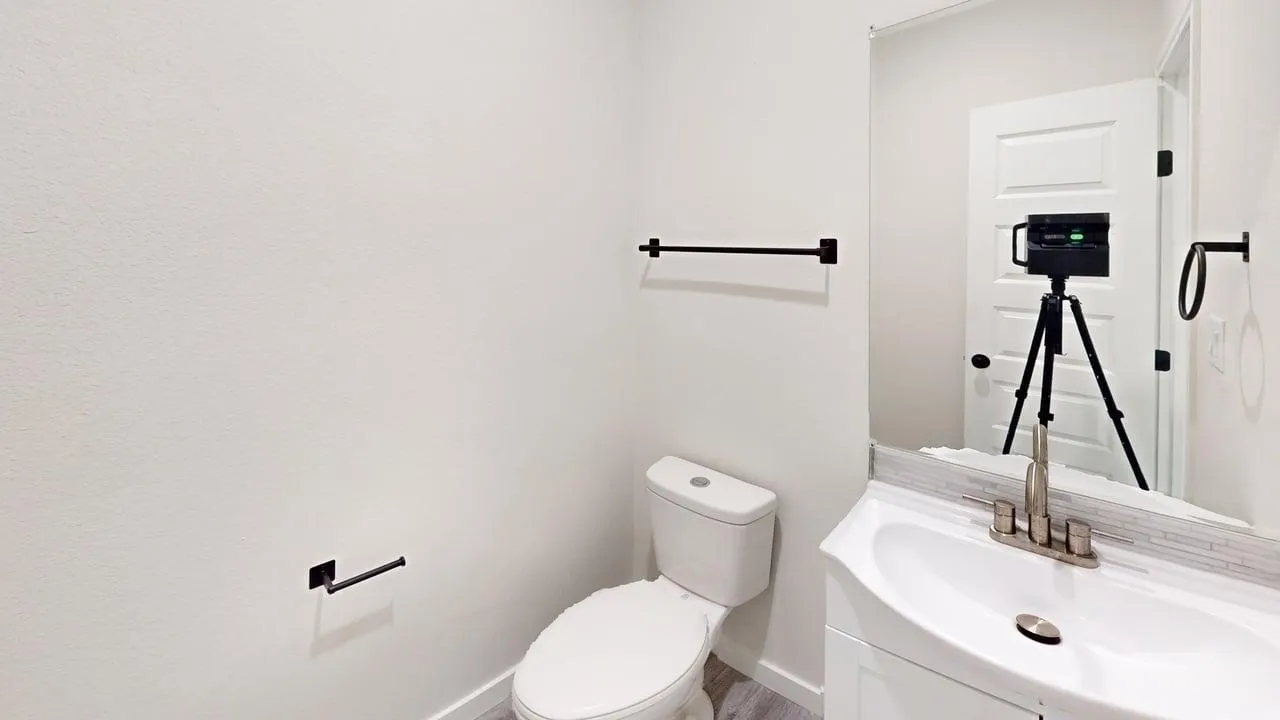 White vanity with an integrated sink, brushed nickel faucet, and a subway tile backsplash