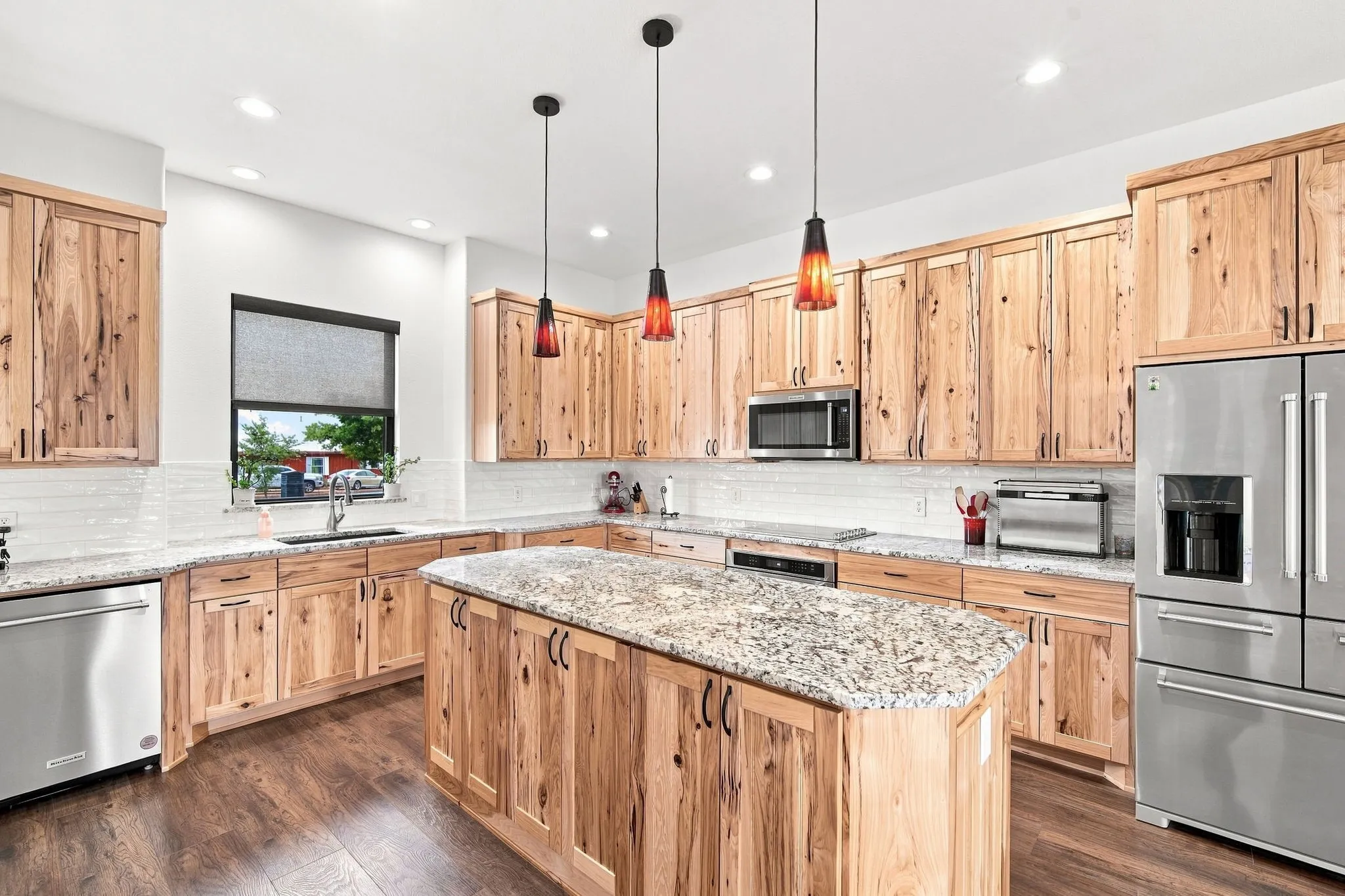 Inviting kitchen with natural lighting, woodwork and luxury finishes.