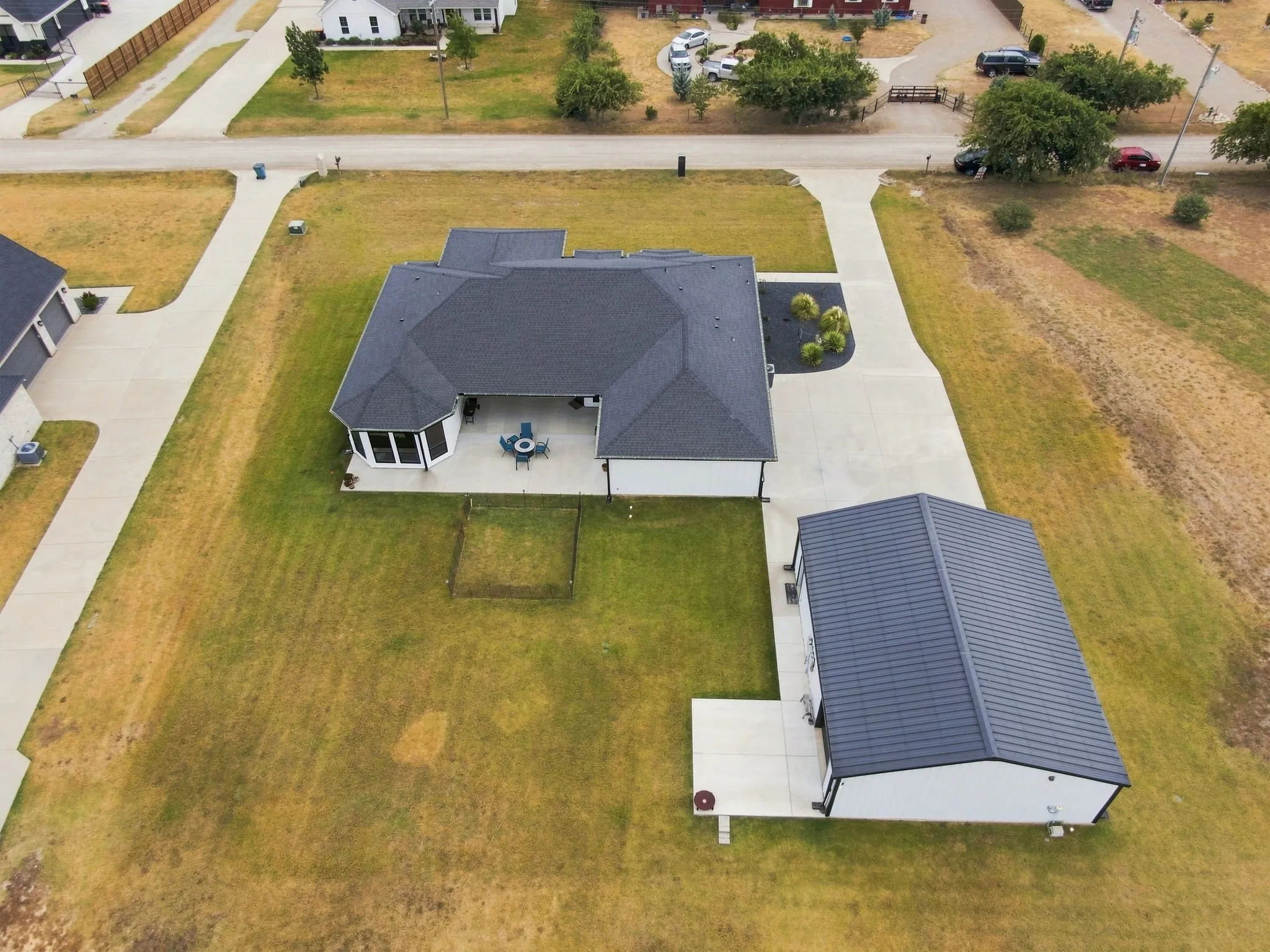 Aerial view of backyard and spacious lot.
