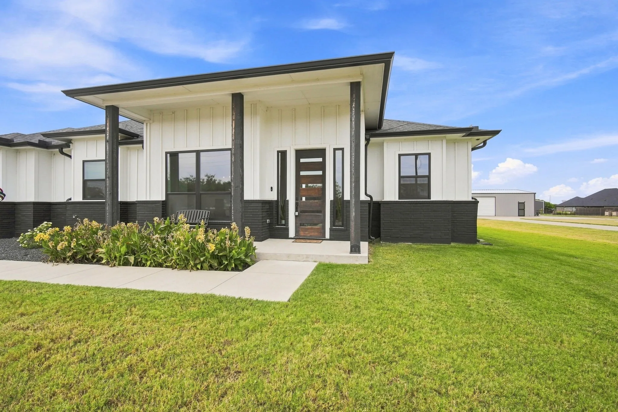 Front exterior with grand front door and porch.