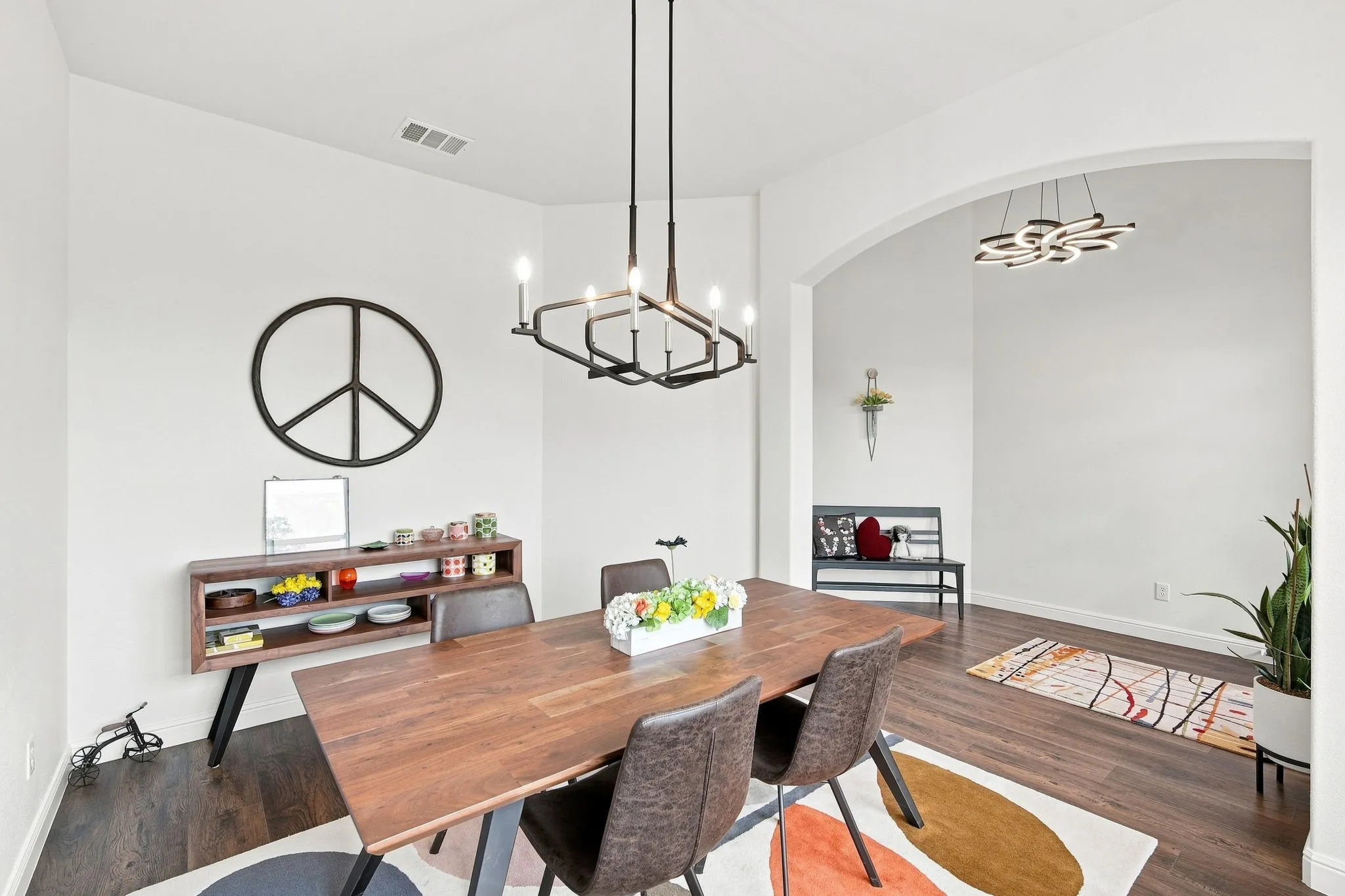 Dining area with large windows for natural lighting and decorative lighting upgrades.
