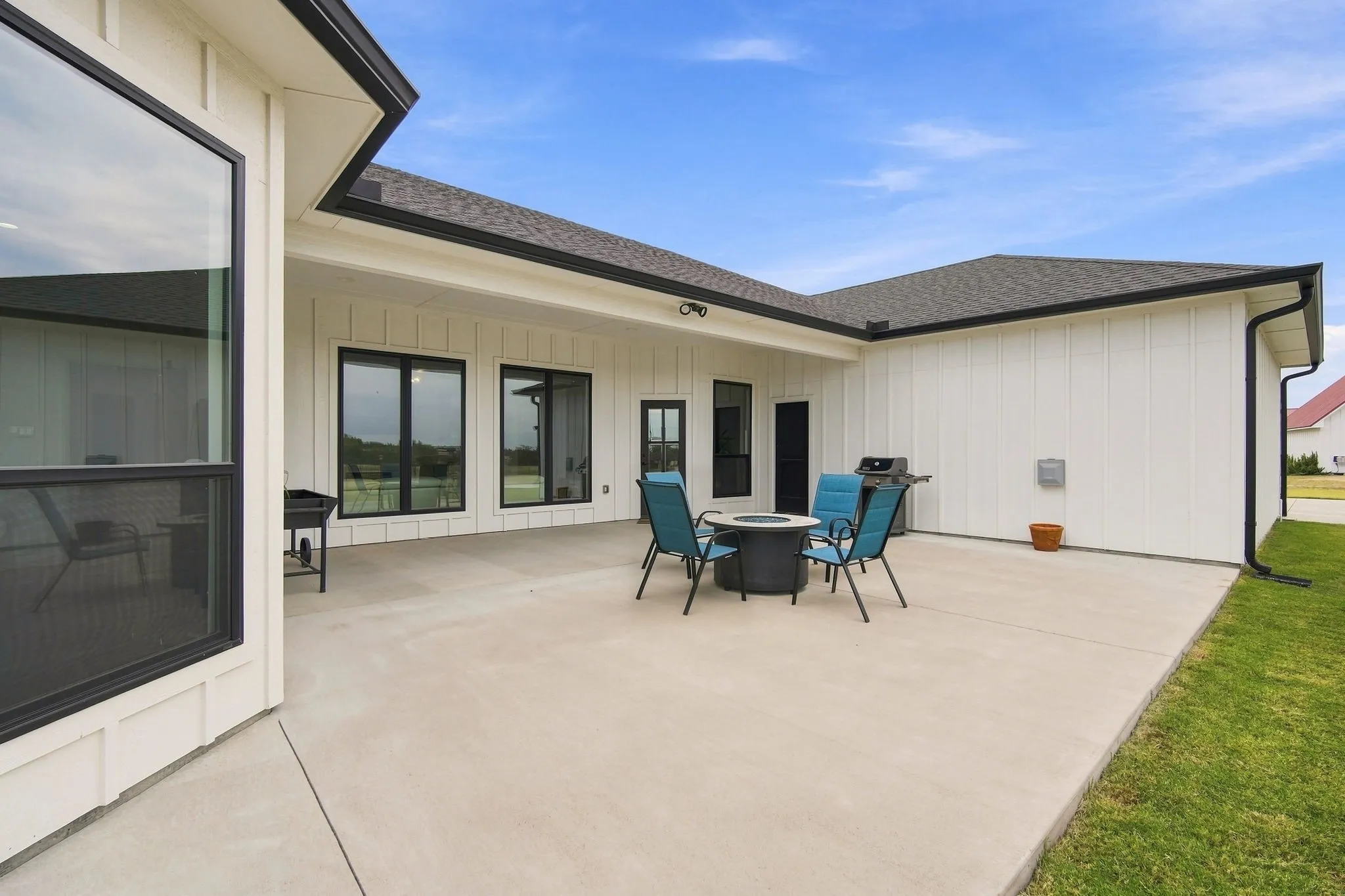 Spacious covered patio looking out on green pastures.