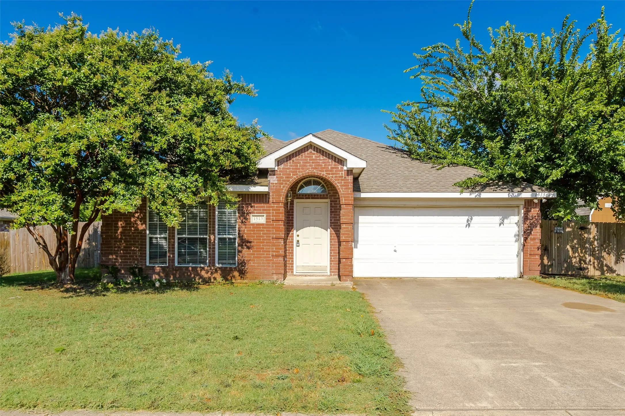 View of front of property with a garage and a front yard