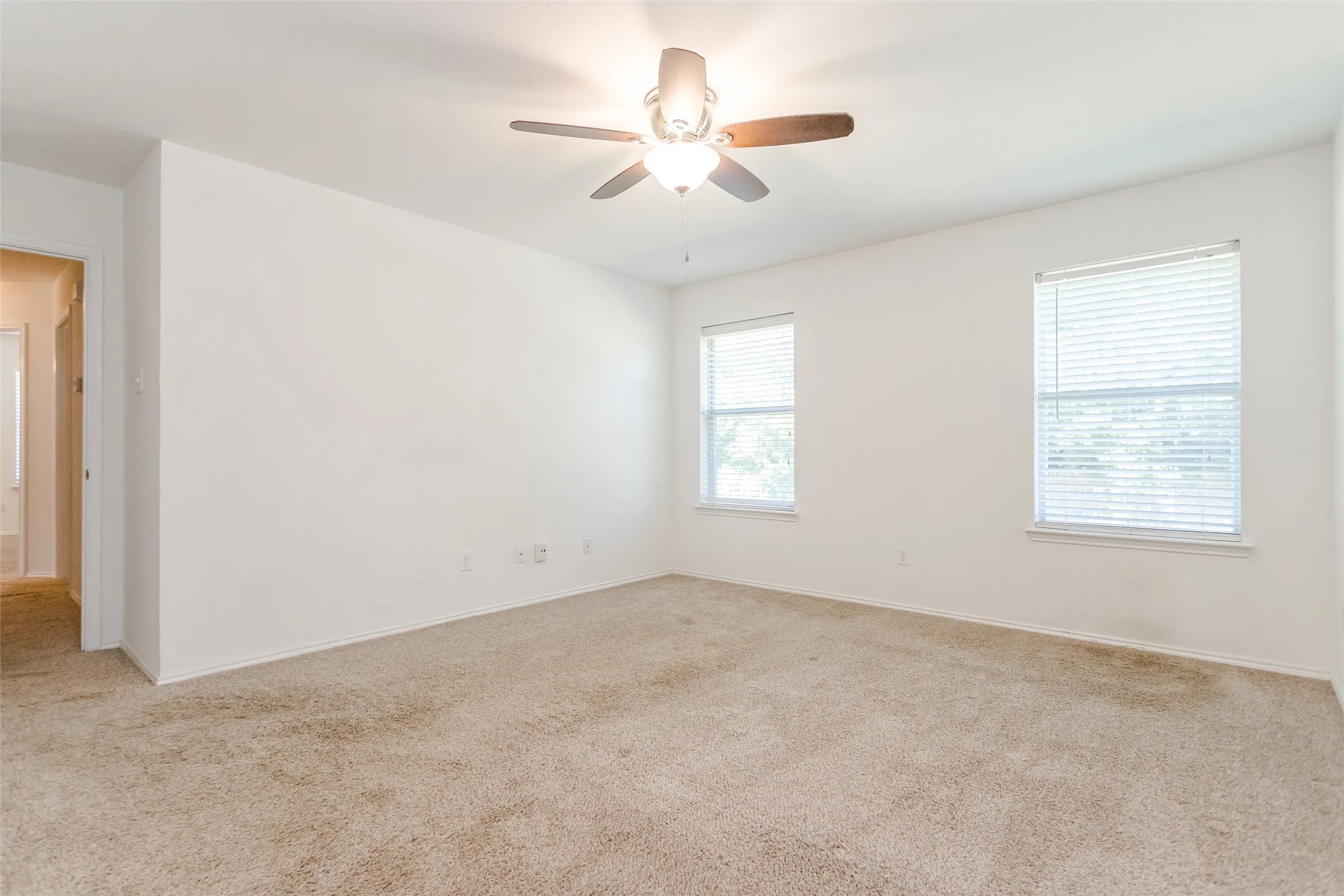 Empty room with carpet and ceiling fan