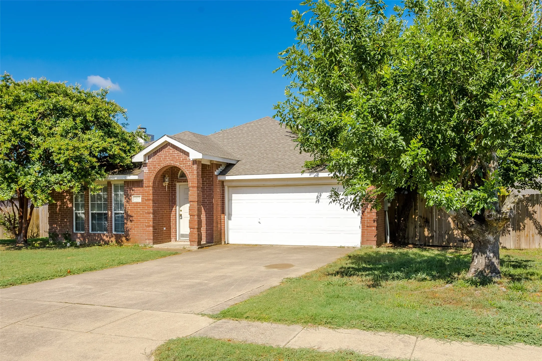 View of front of property with a garage and a front yard