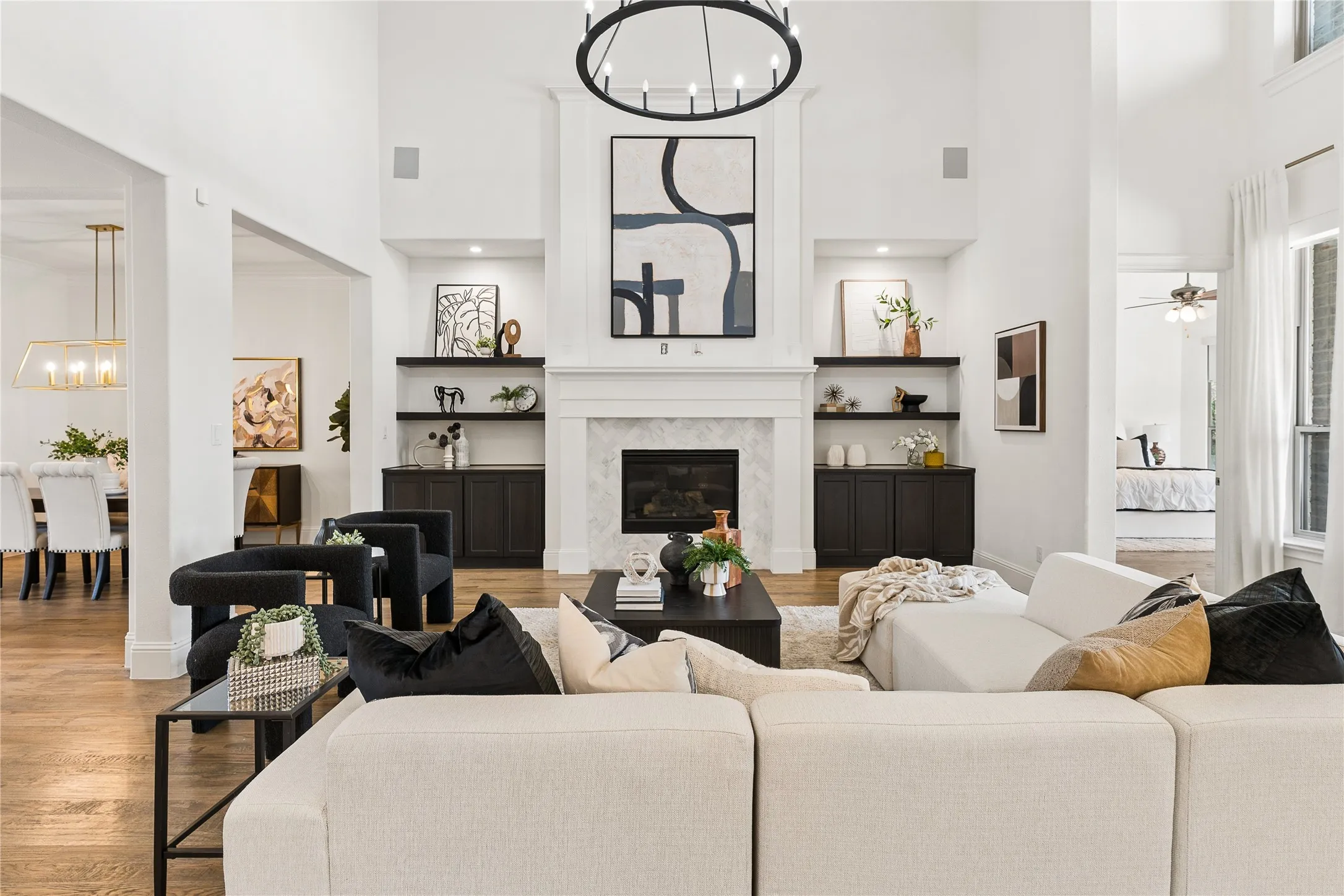 Light filled family room with soaring ceilings, a floor to ceiling fireplace, and seamless flow to the chef's kitchen and breakfast room.