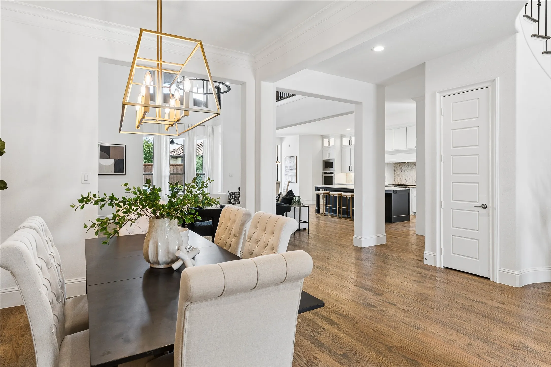 Elegant formal dining room showcasing architectural details and wood flooring