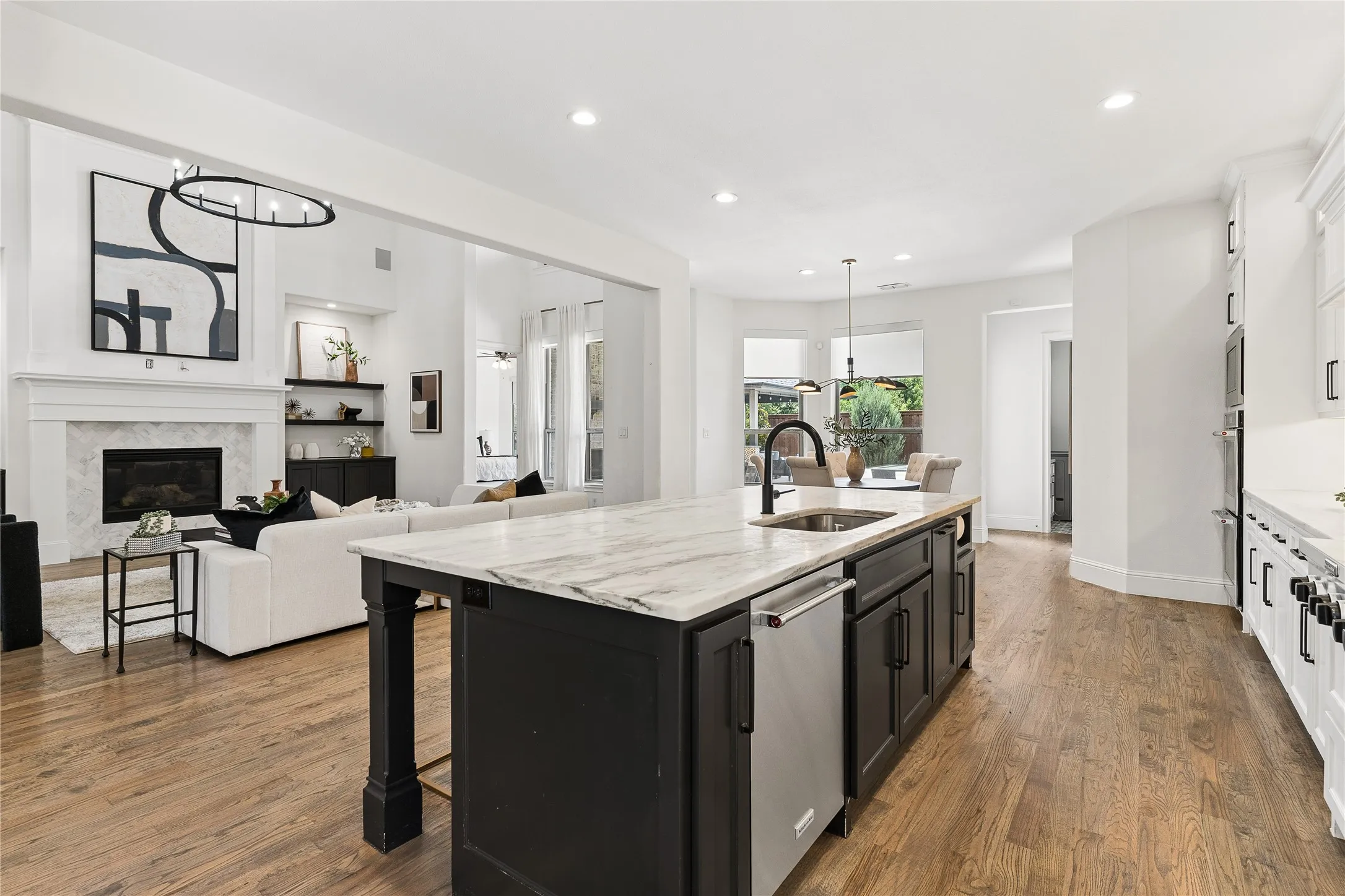 Chef’s kitchen with 6 burner gas cooktop, double oven, oversized island, range hood, and walk-in pantry with planning station.